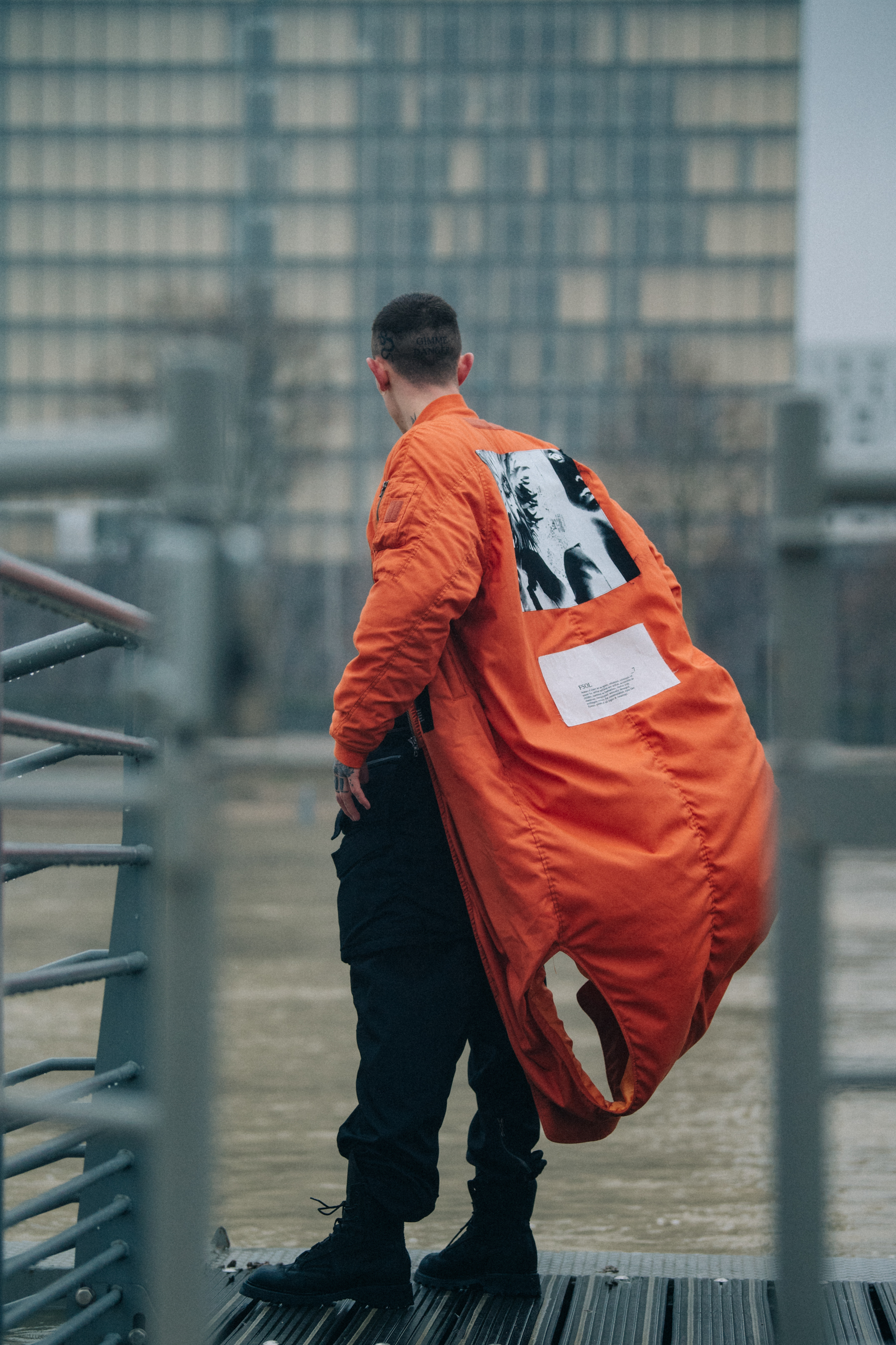 Model wearing open orange coat