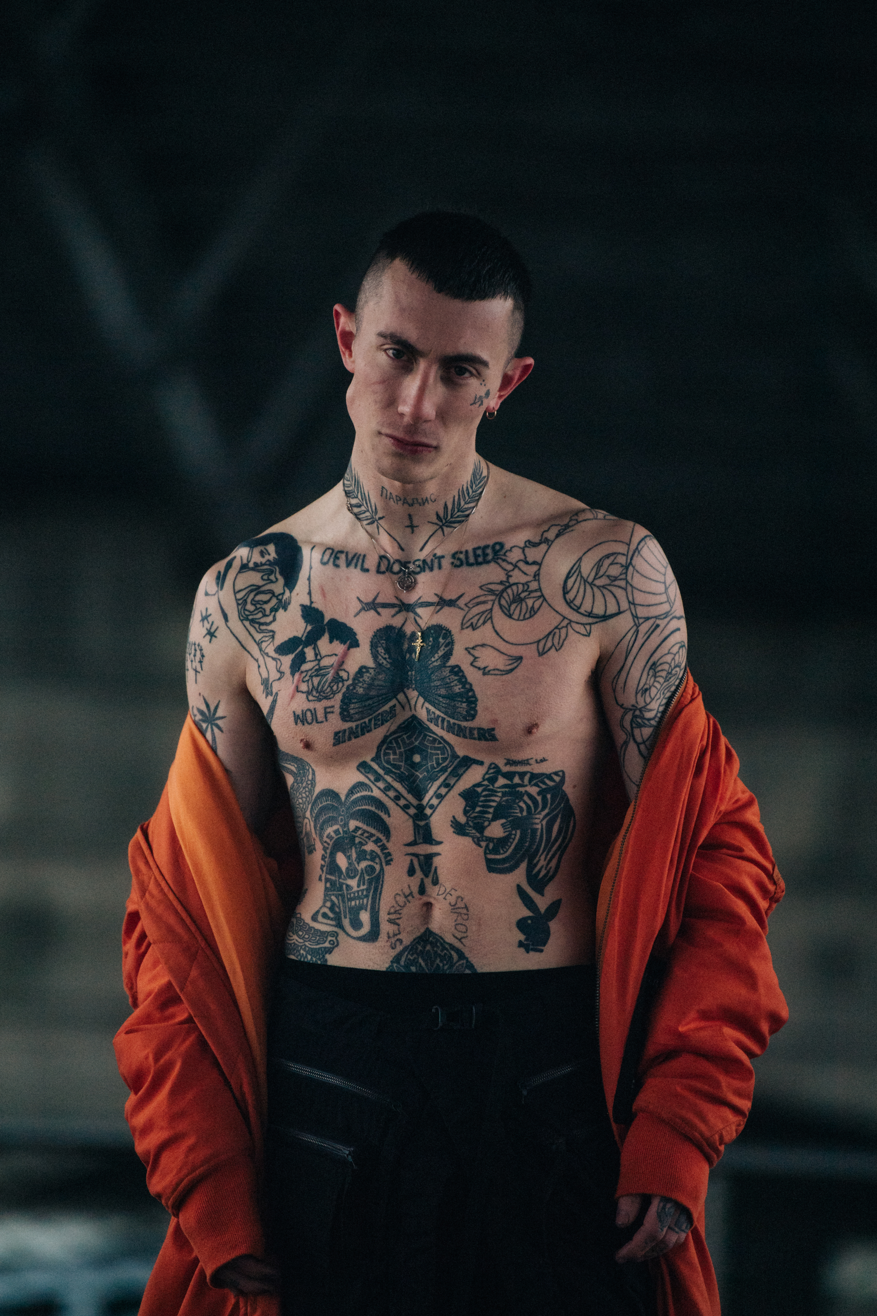 Model wearing open orange coat