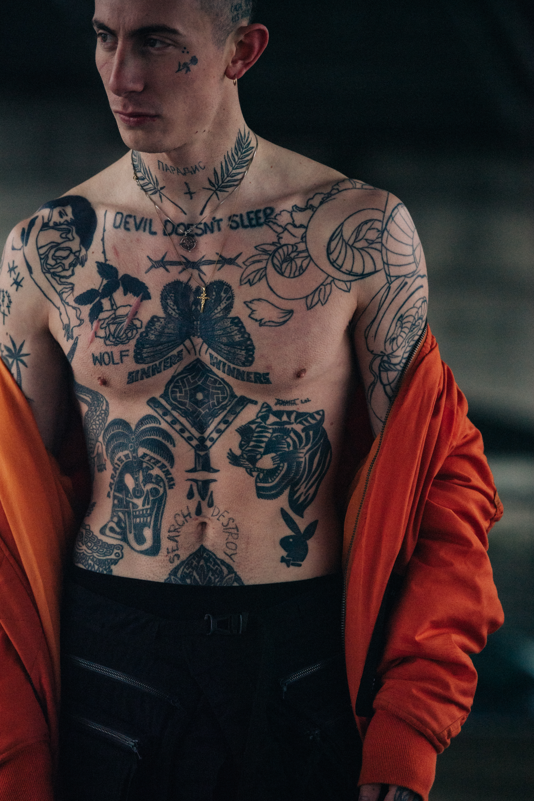 Model wearing open orange coat