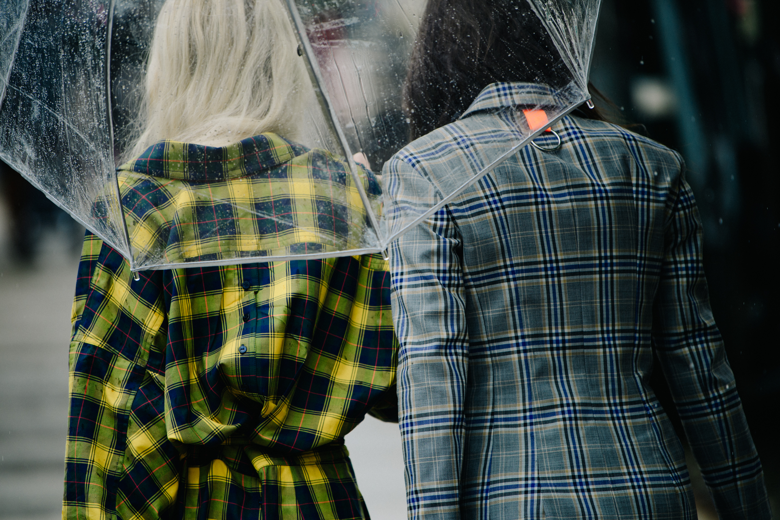 Two women wearing check coats