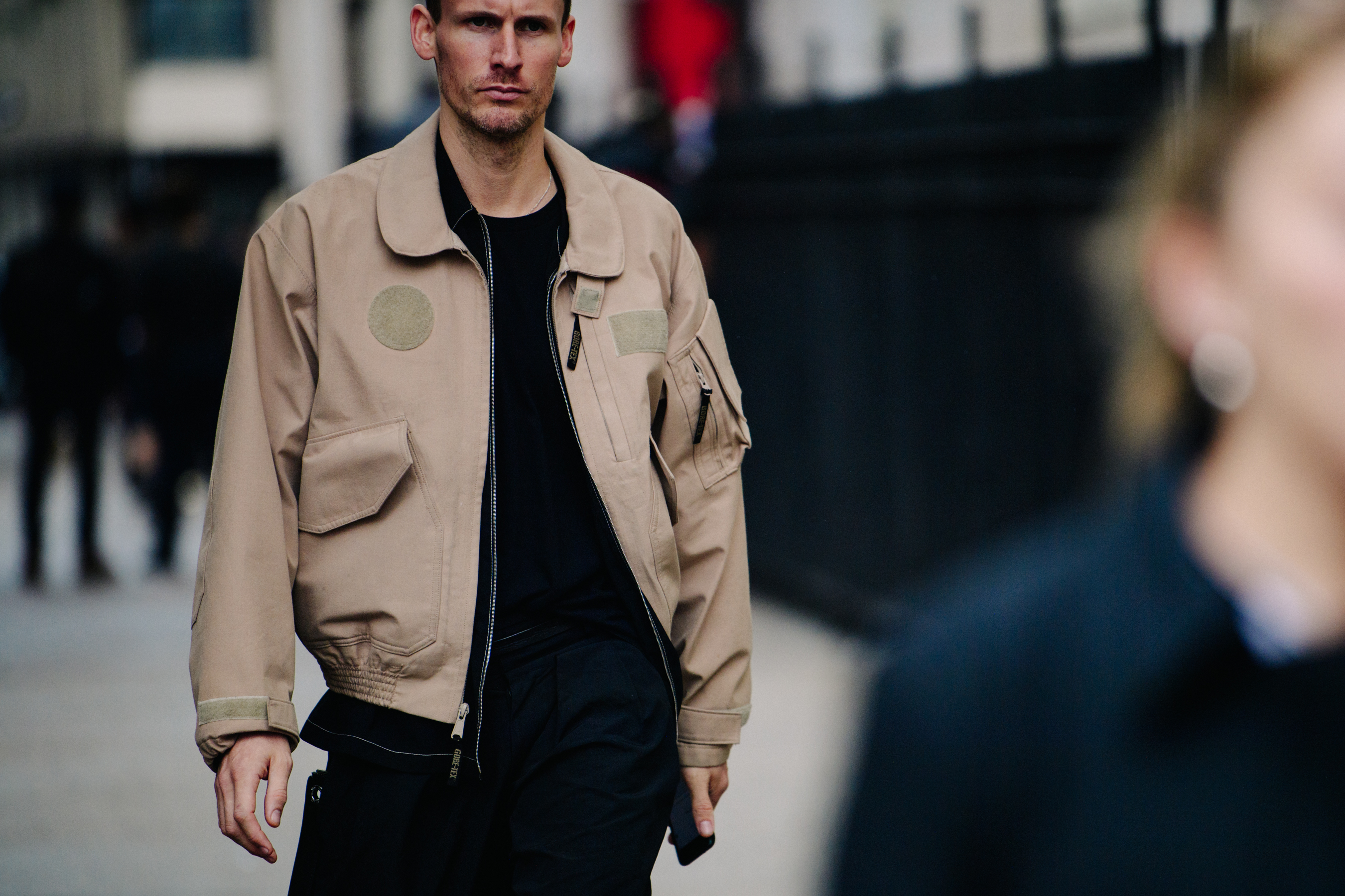 Man wearing brown flight jacket
