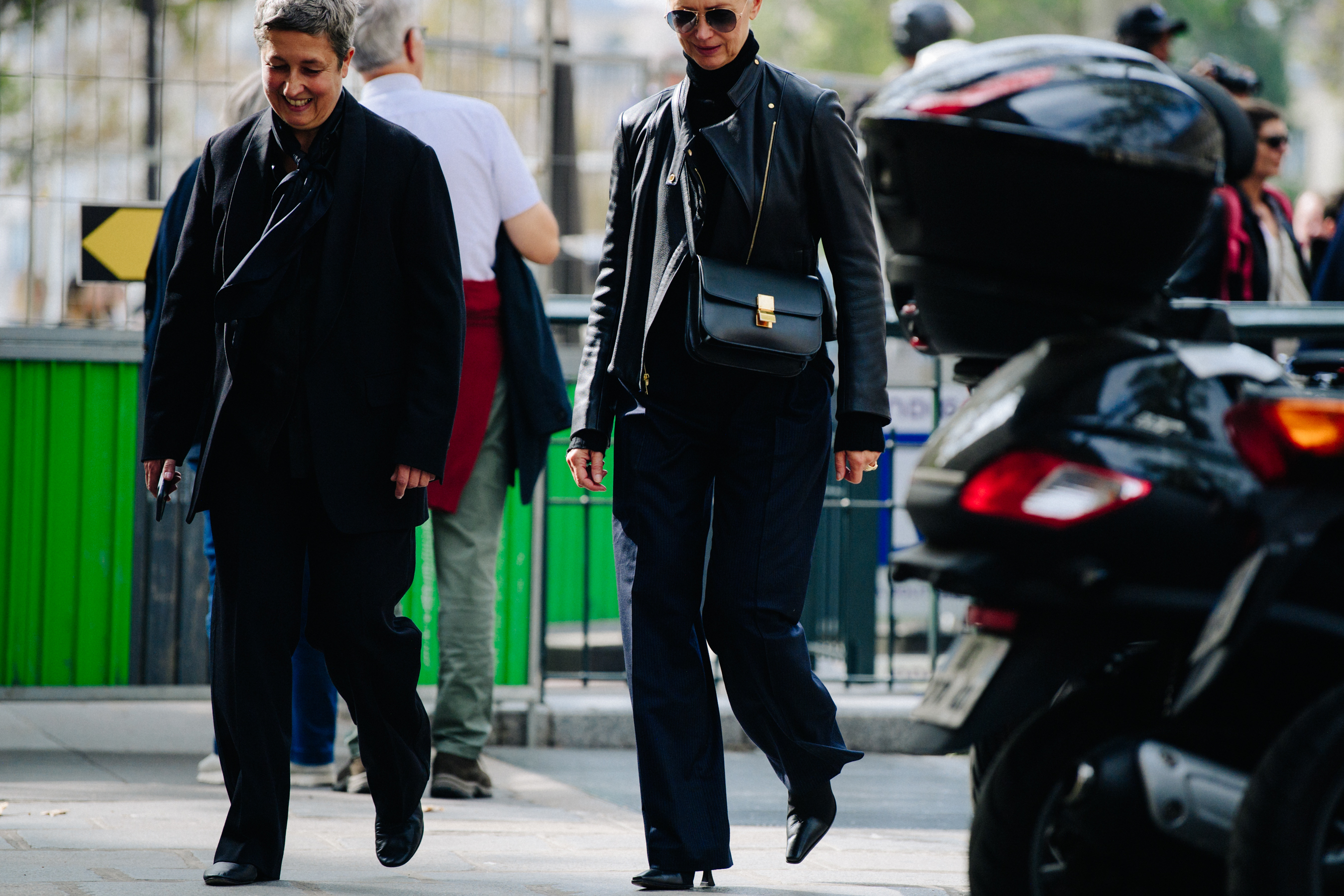 Two women wearing black outfits