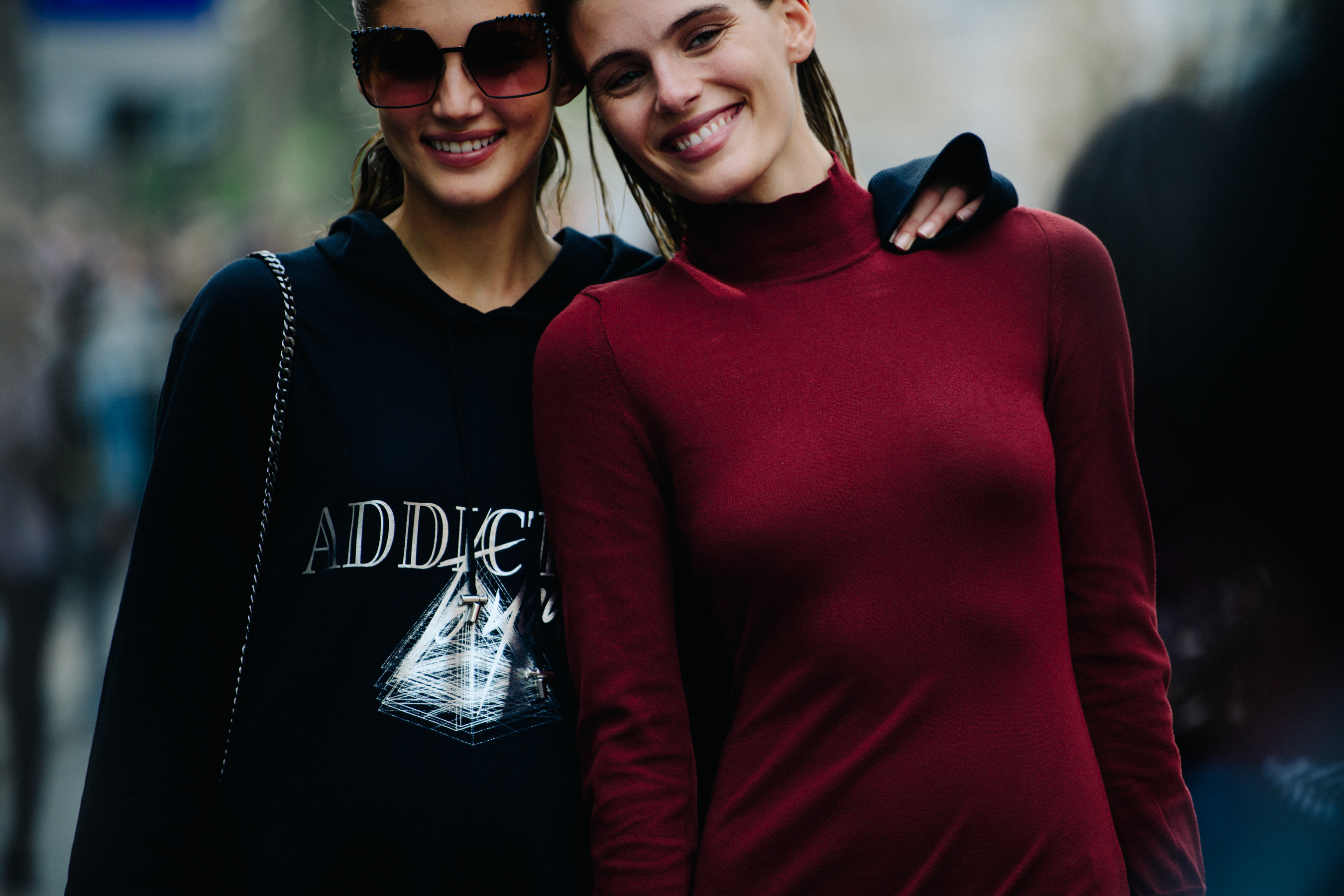 Two models wearing dark colours