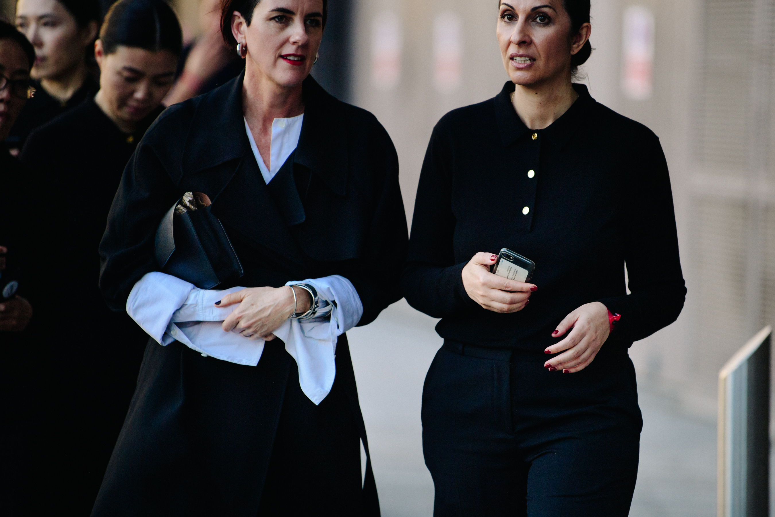 Two women wearing black