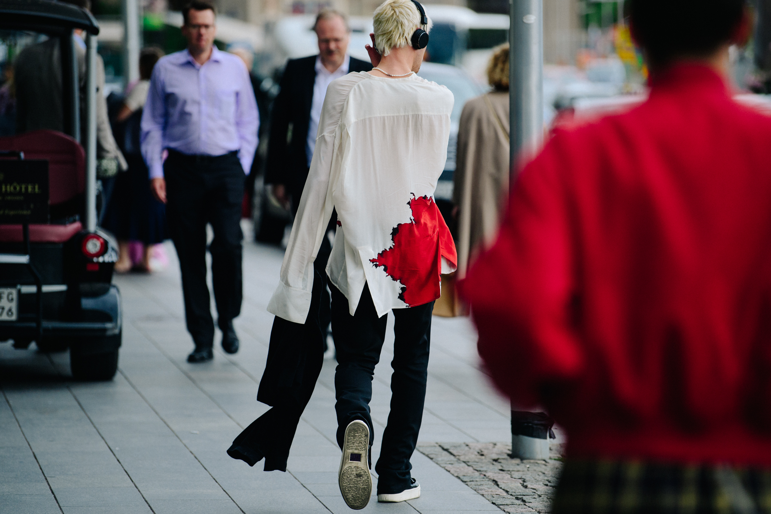 Man wearing white shirt with red detail