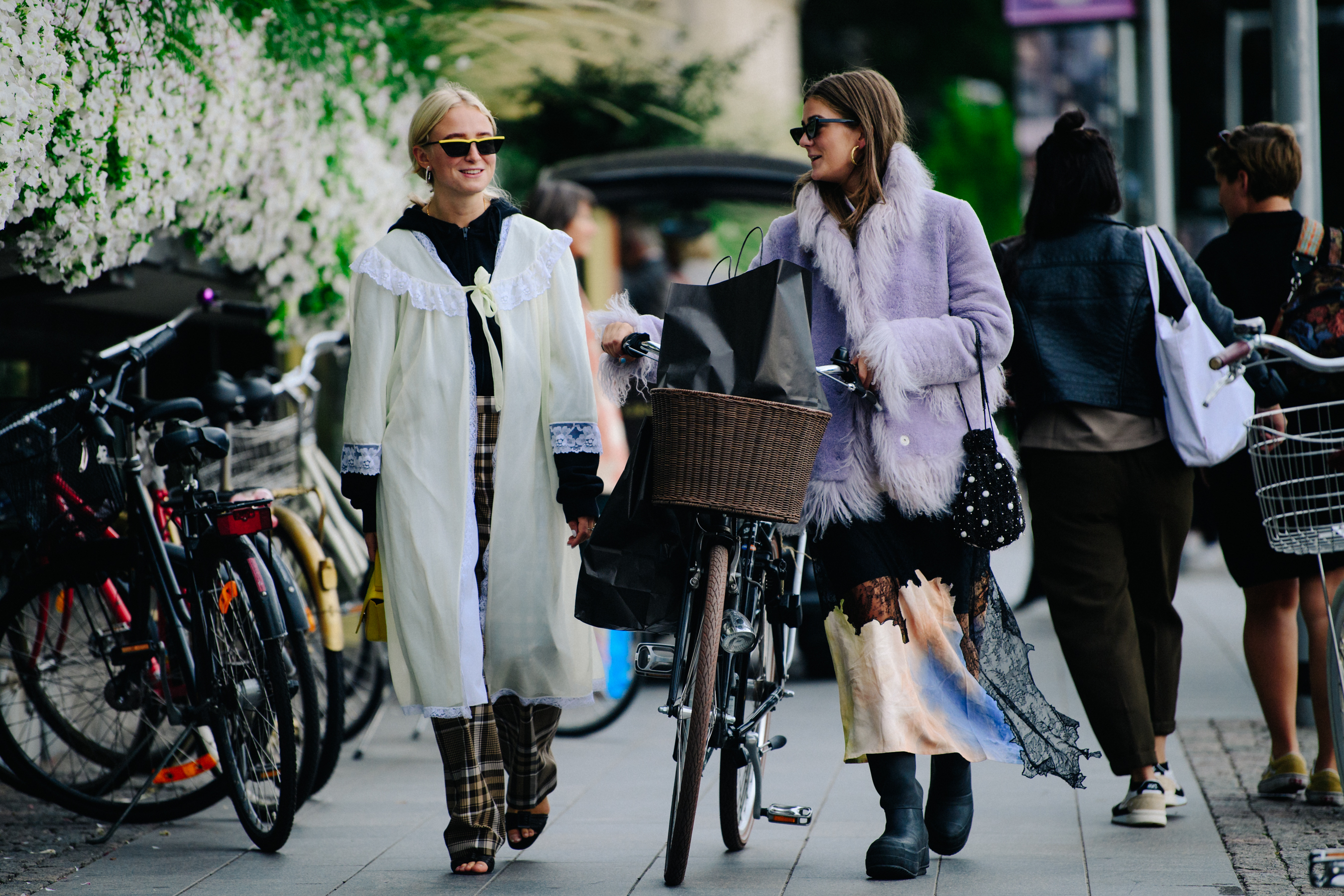 Two women wearing long jackets