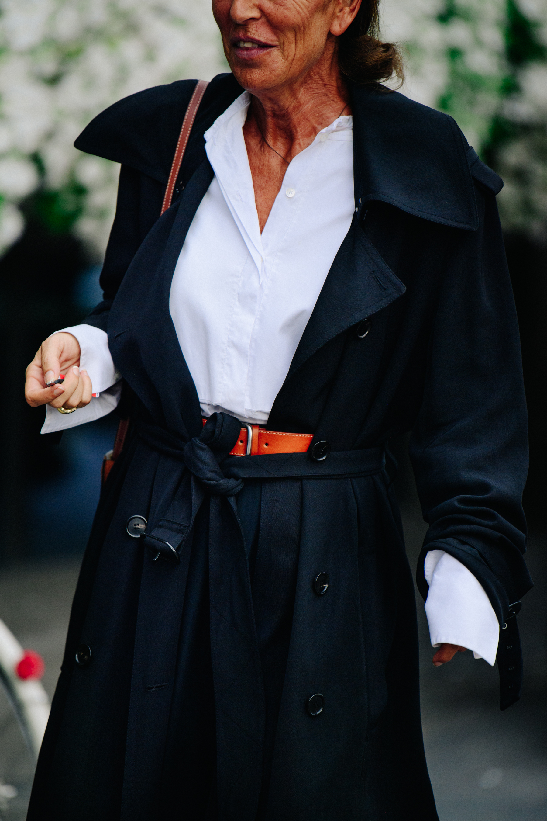 Woman wearing black beletd coat