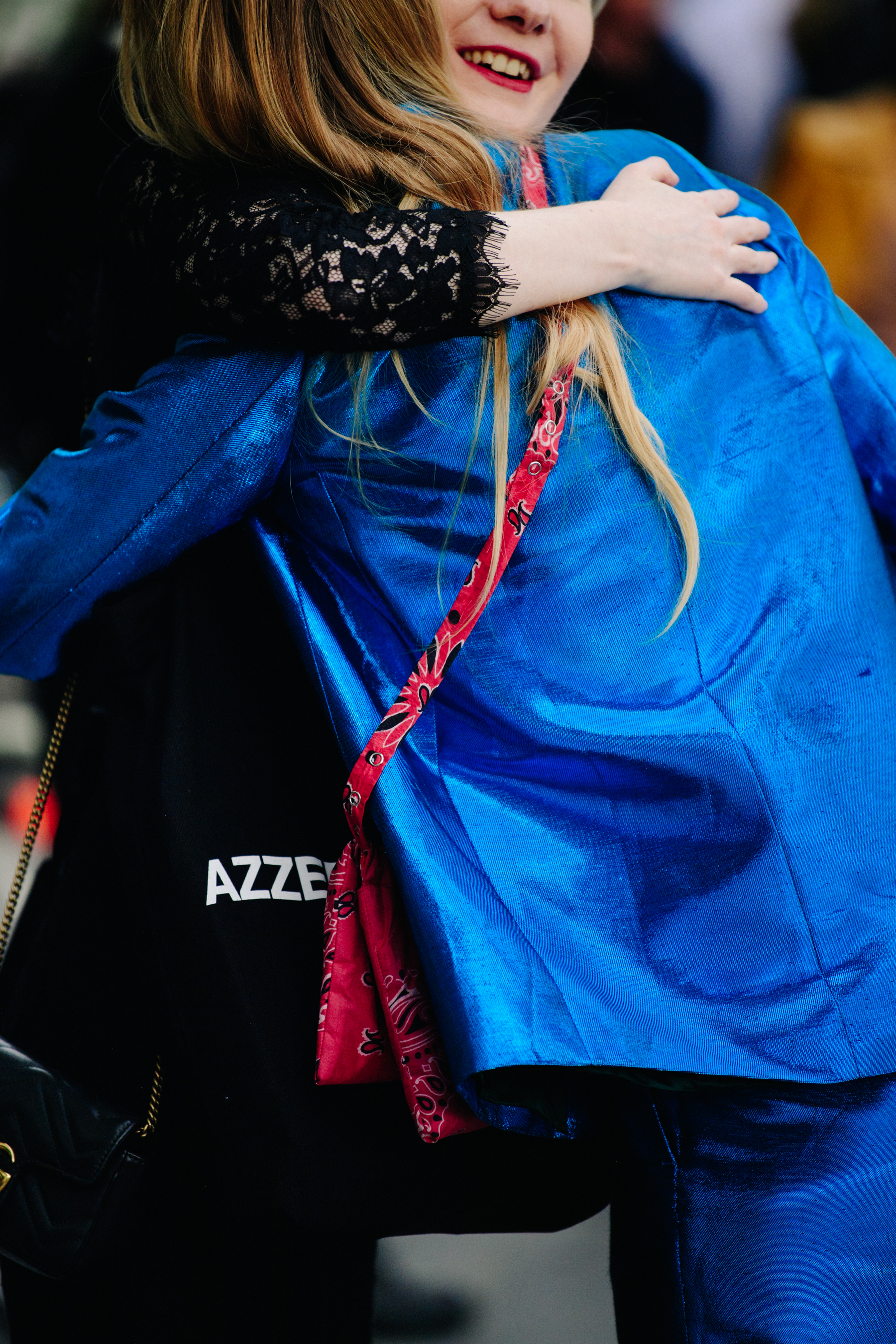 Women hugging in blue shirt