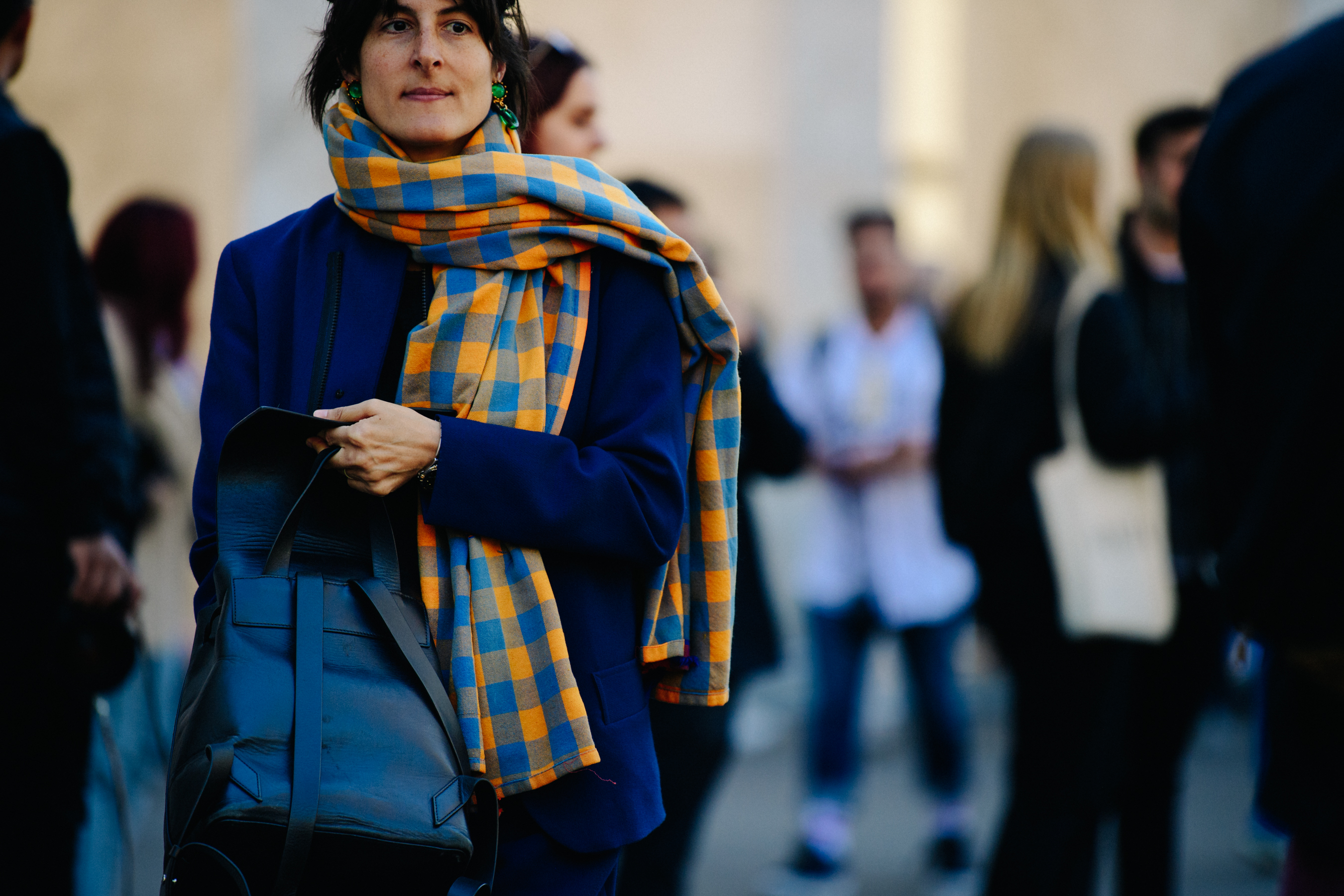 Woman wearing blue and orange scarf