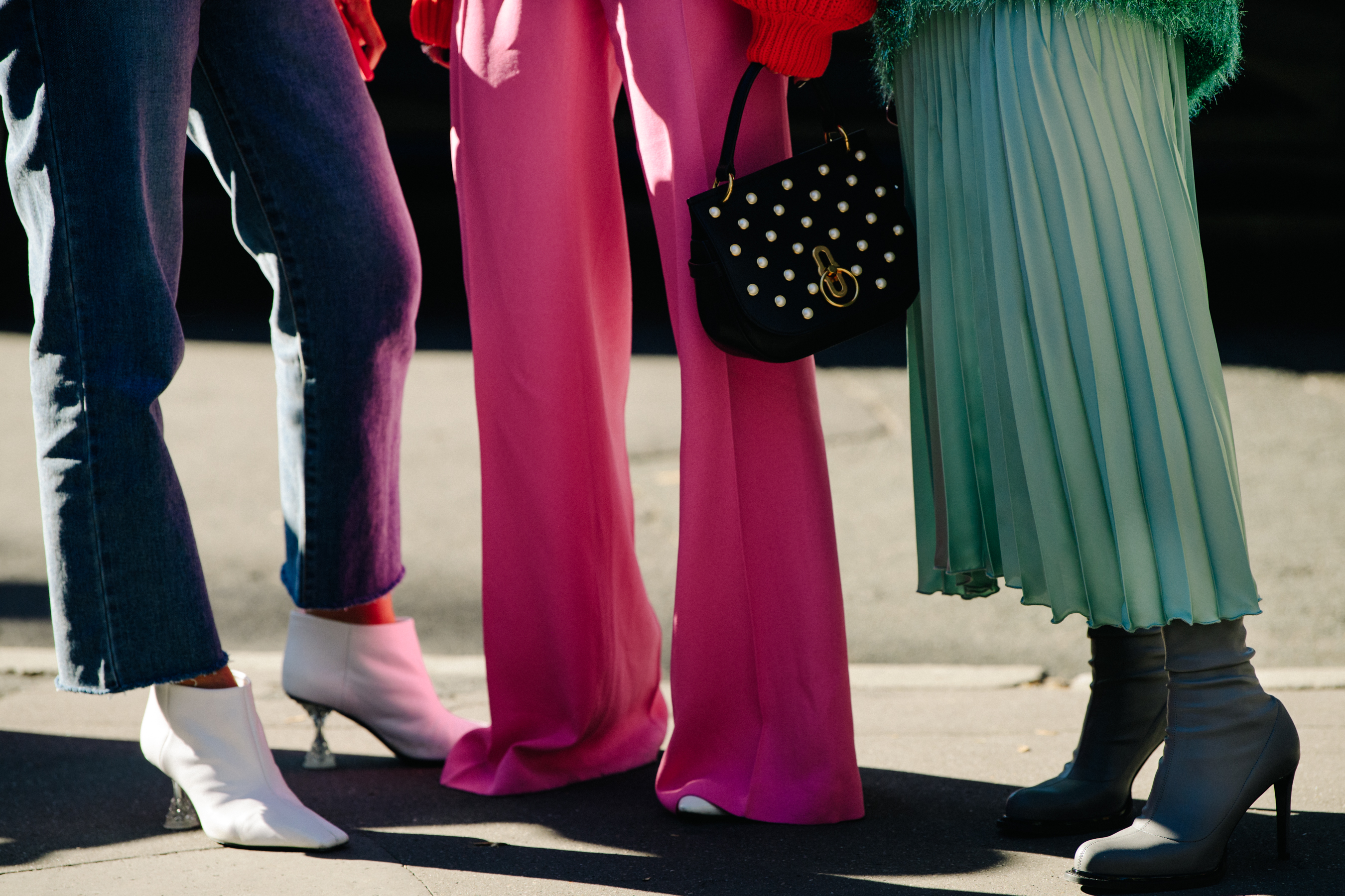 Three women wearing colourful clothing