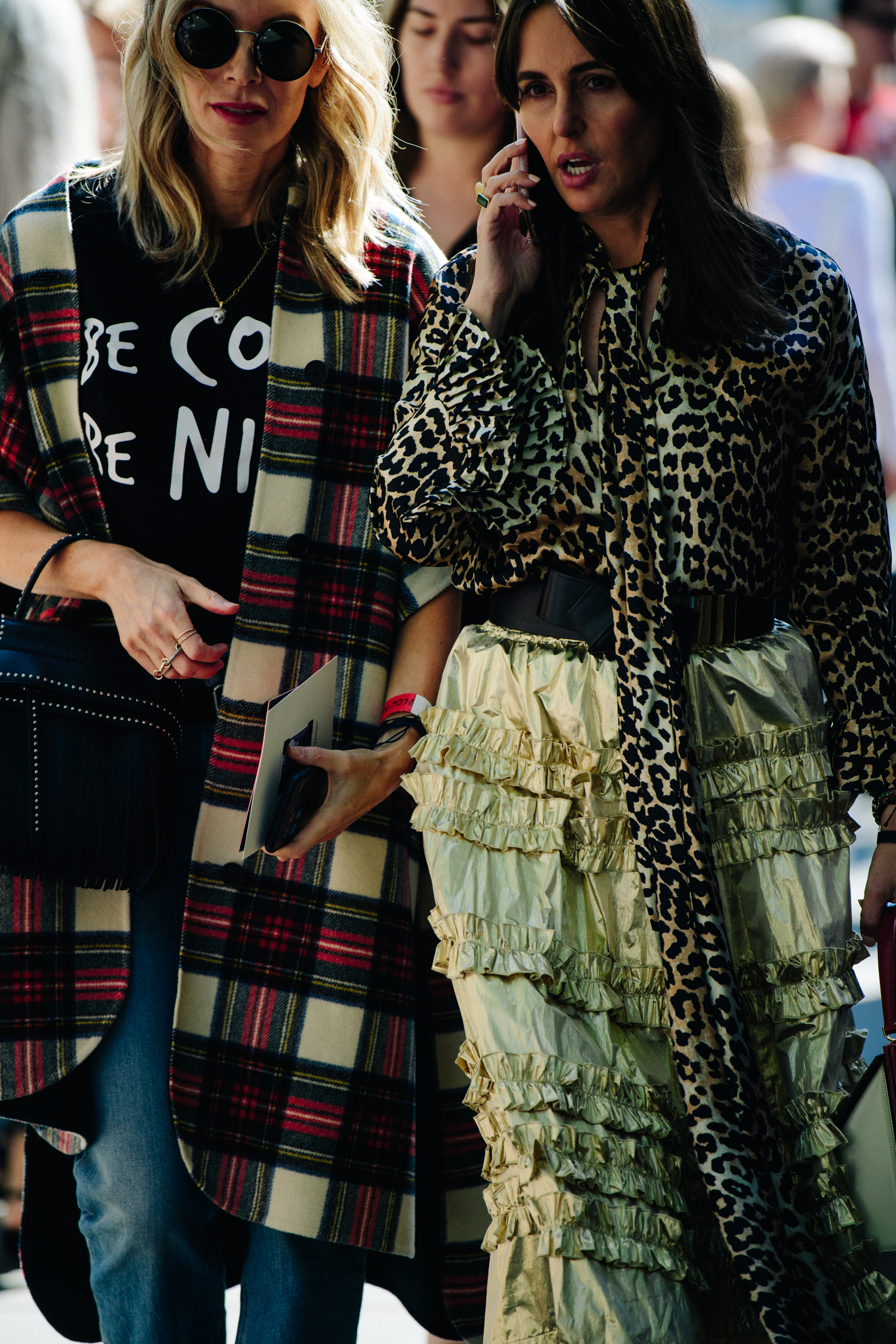 Two women wearing long pattern outfits