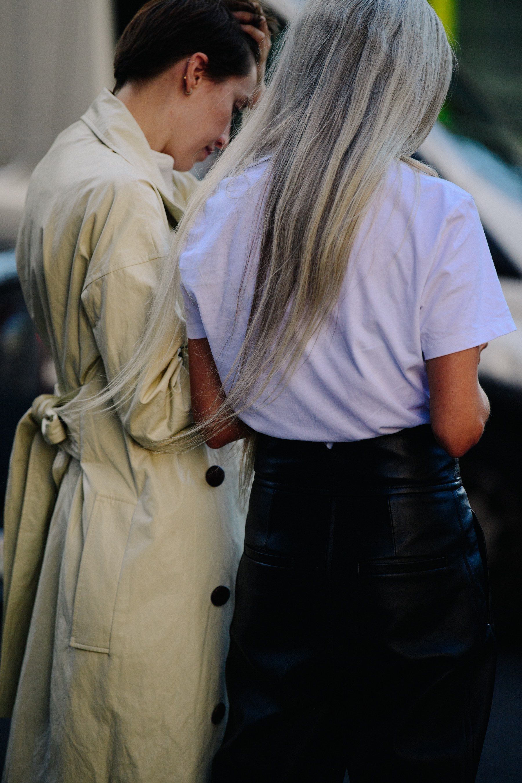 Two women wearing white and cream