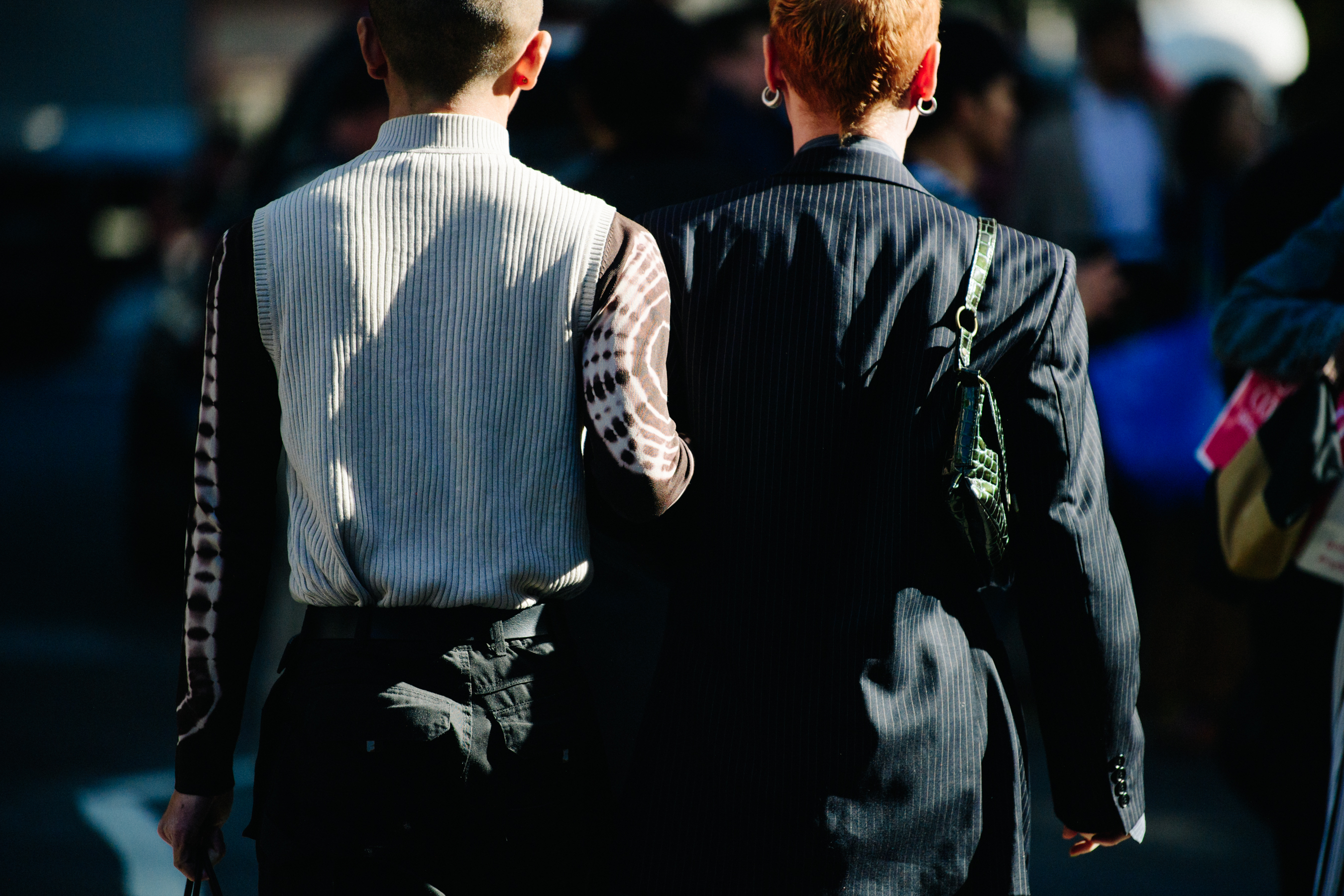 Two men wearing grey and navy stripes