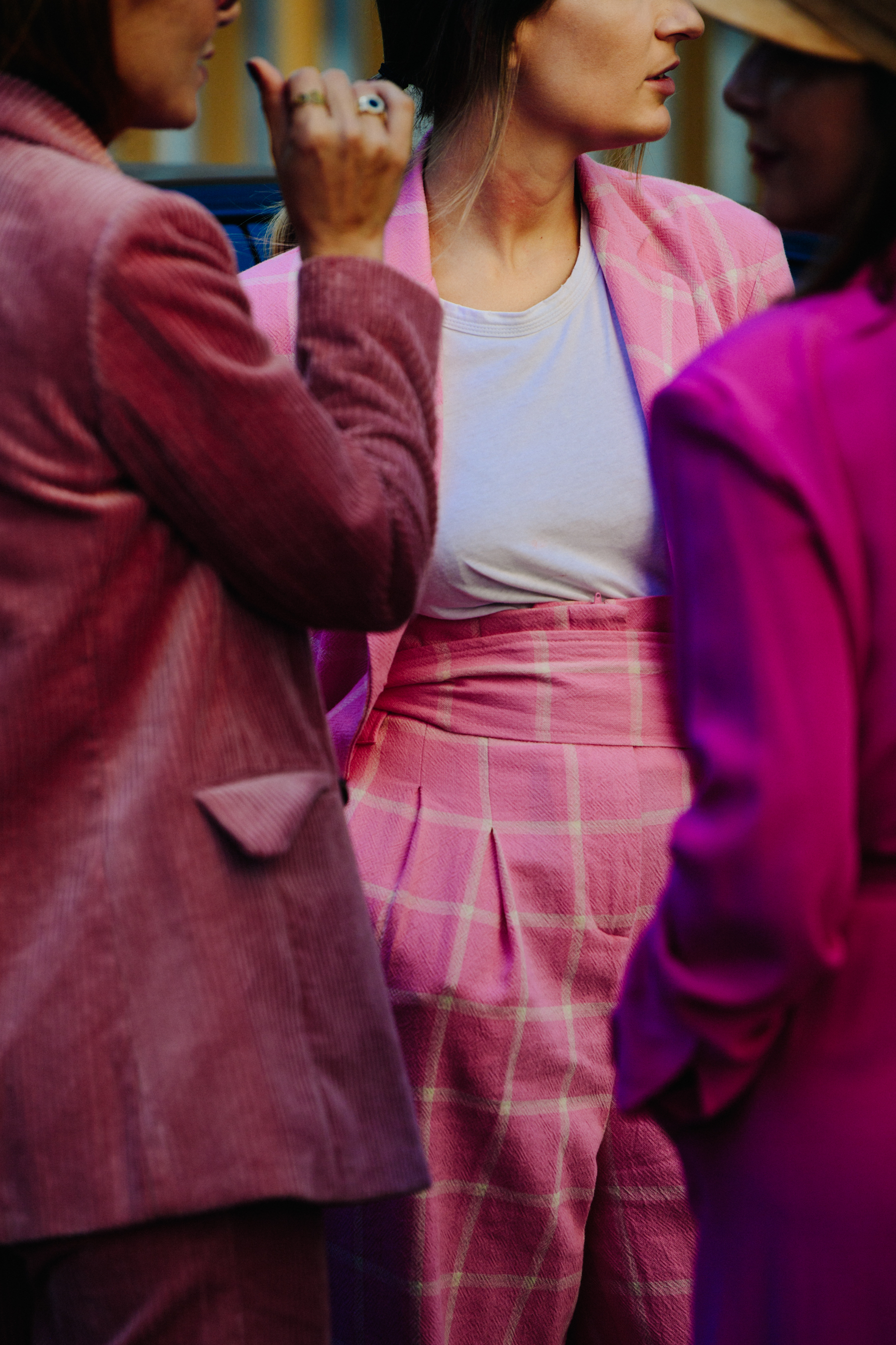 Three women wearing pink
