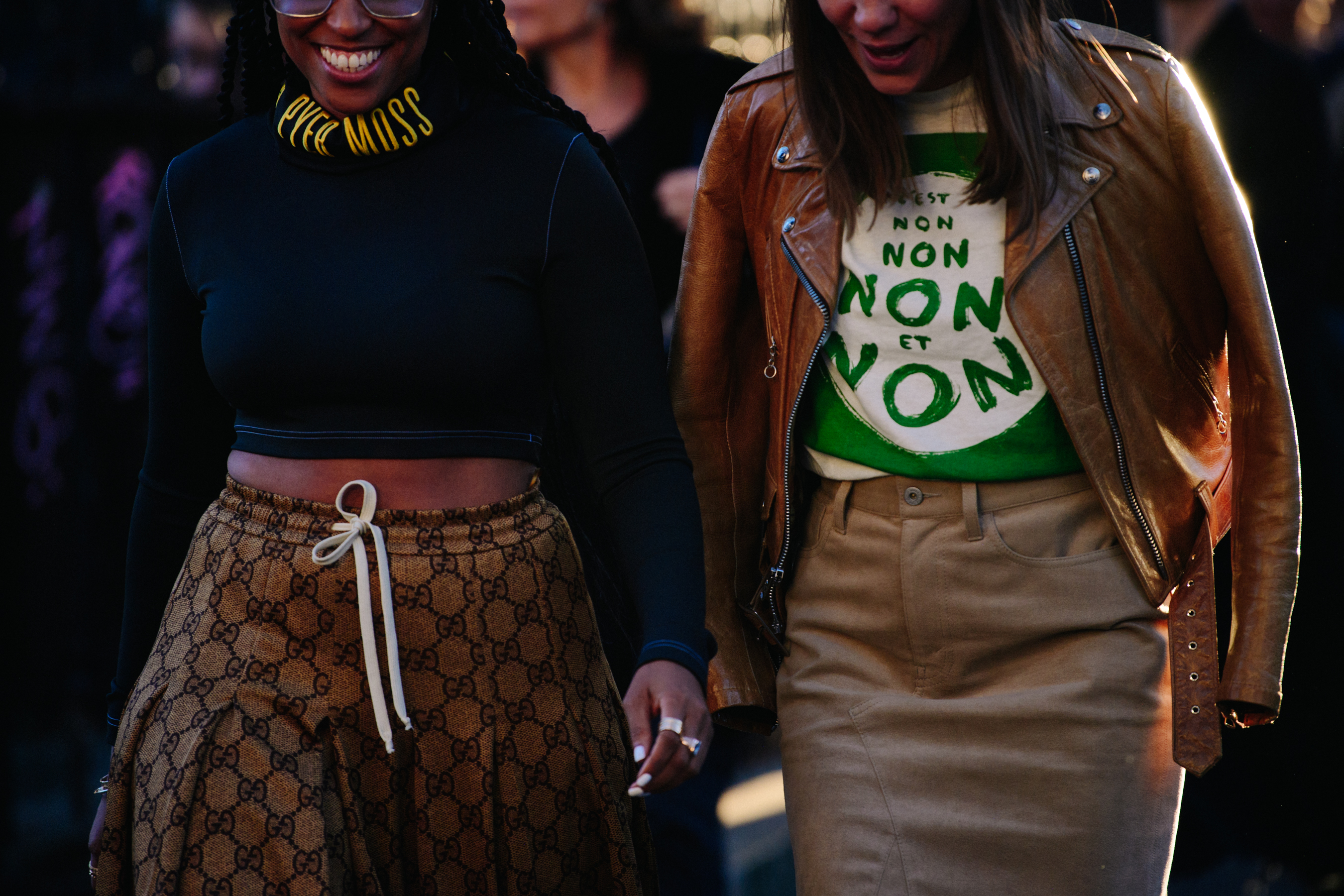 Two women wearing brown outfits