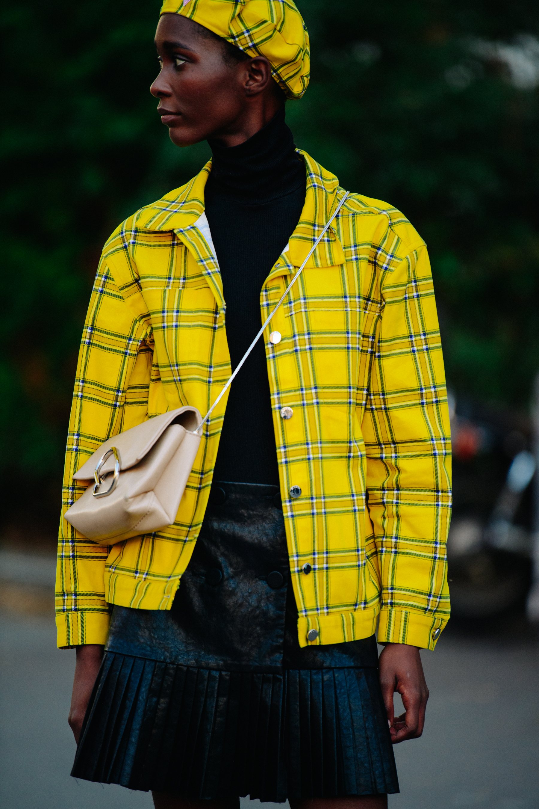 Woman wearing yellow jacket and beret