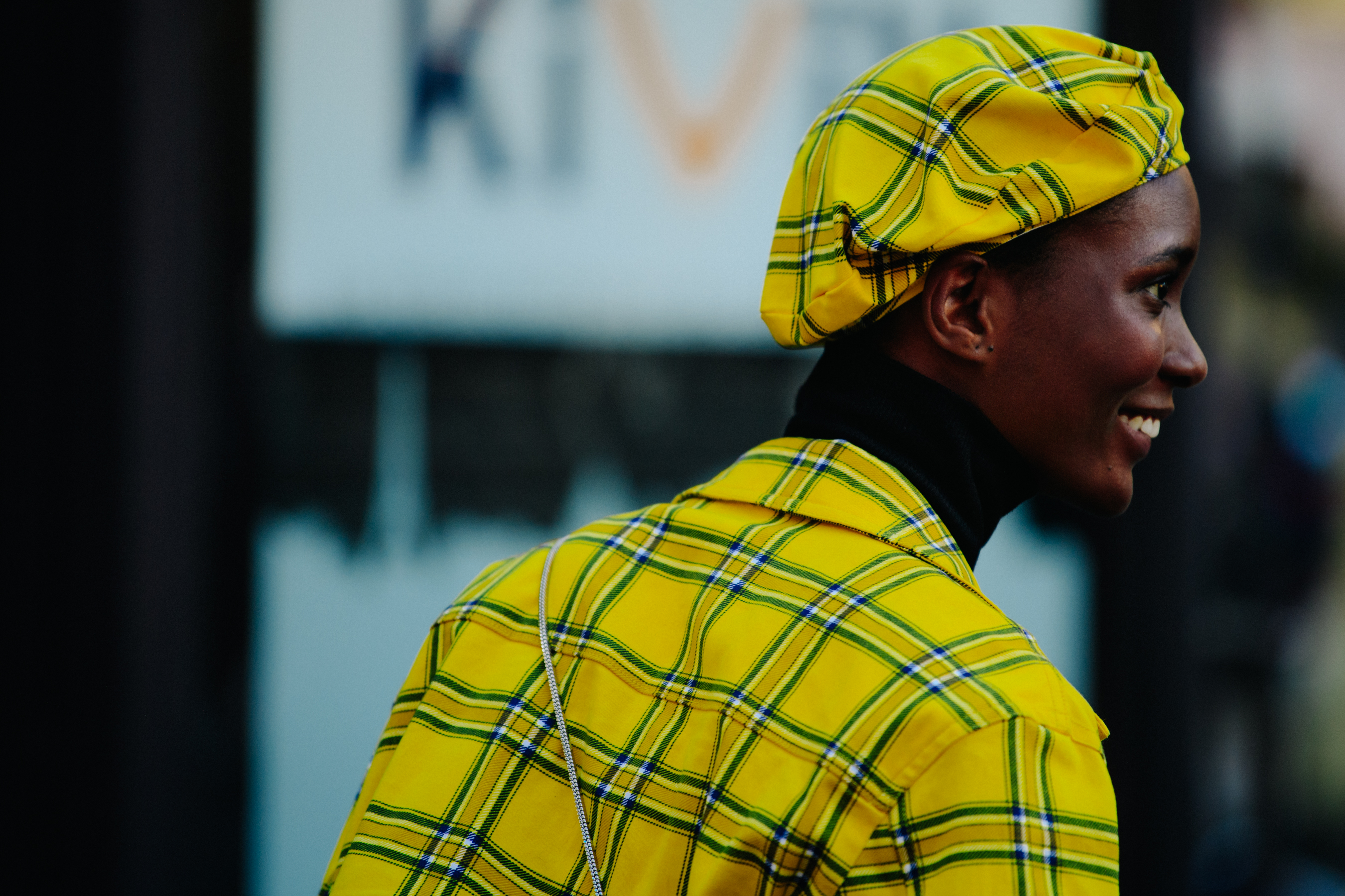 Woman wearing yellow jacket and beret