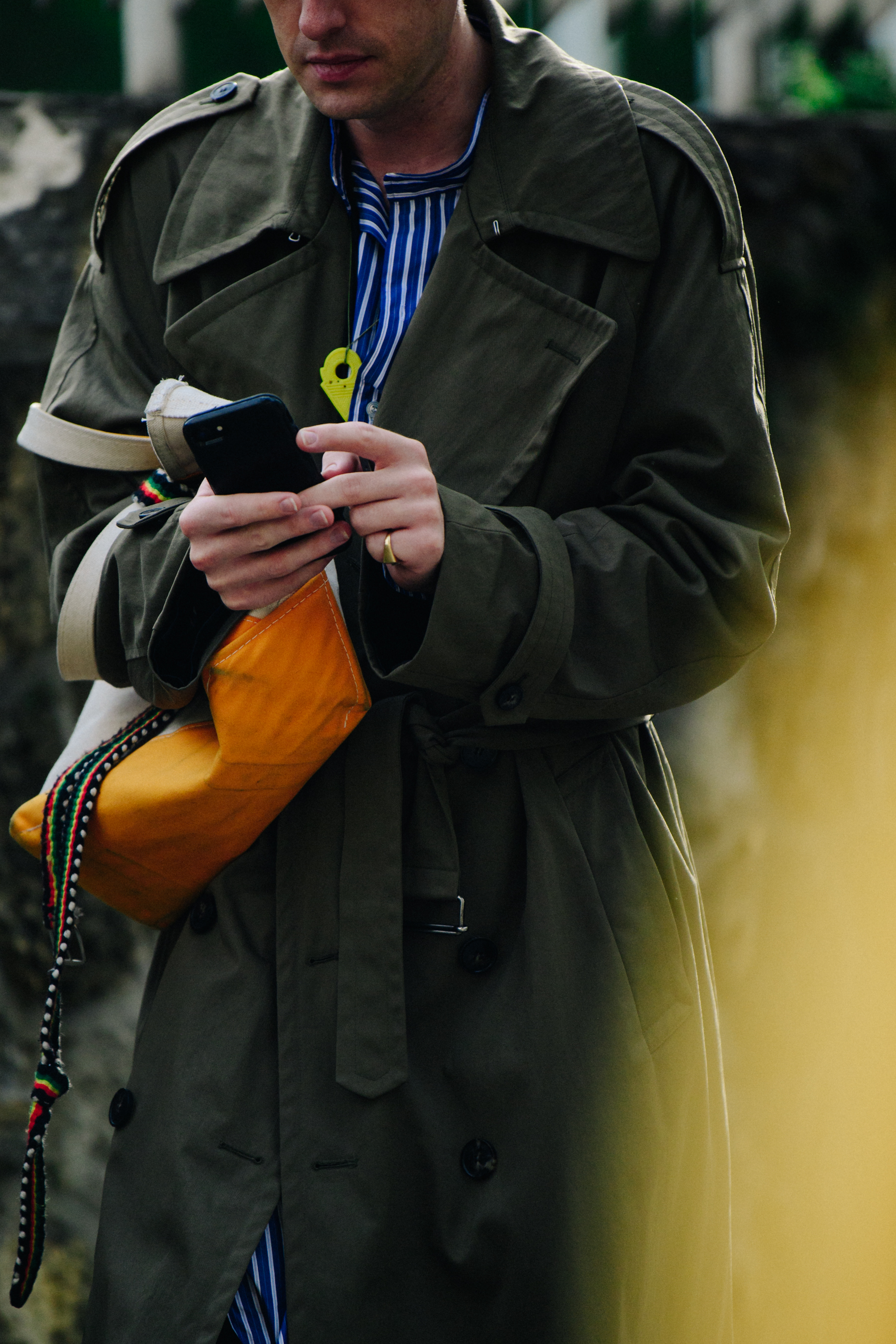 Man wearing dark green trench coat