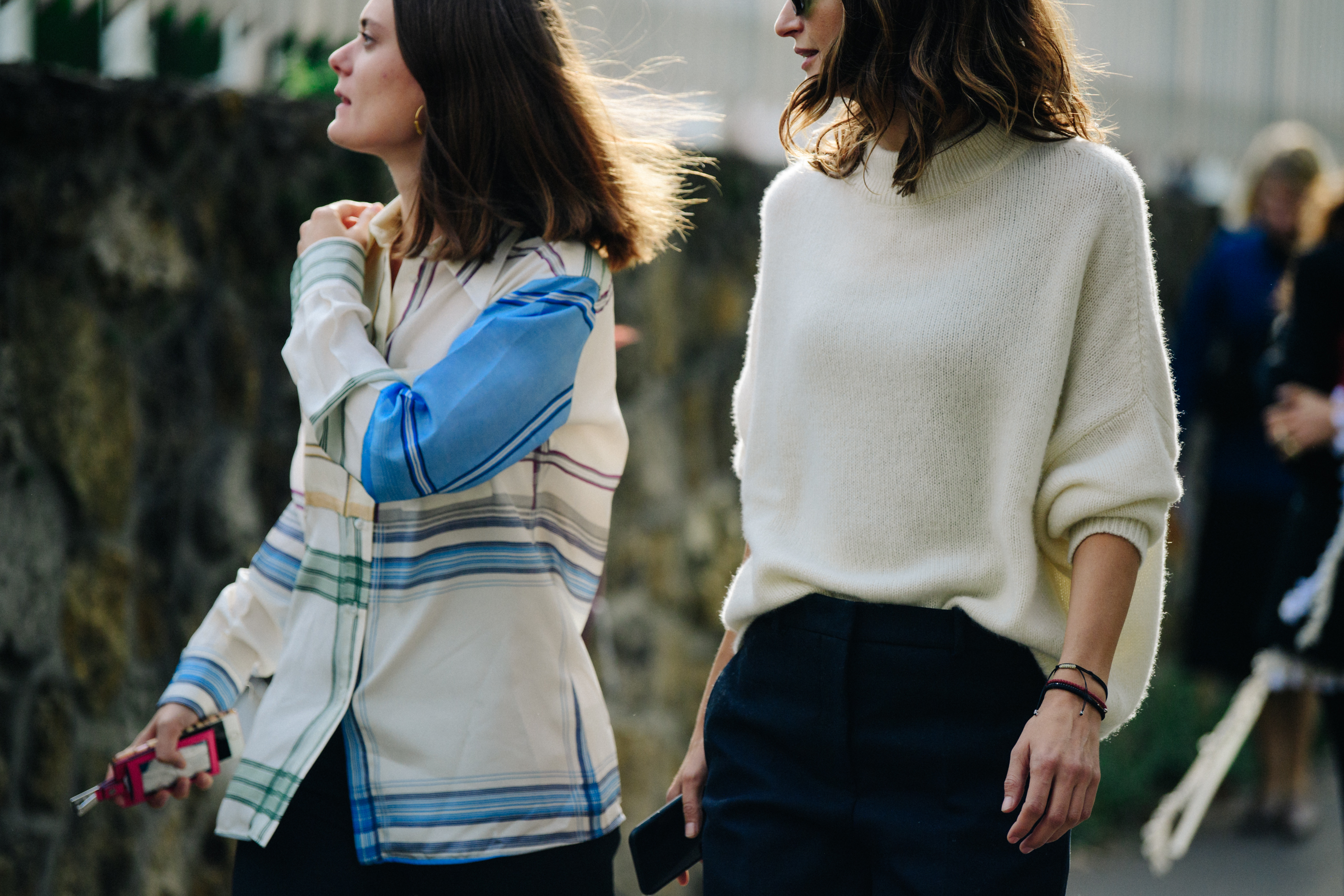 Two women wearing light tops