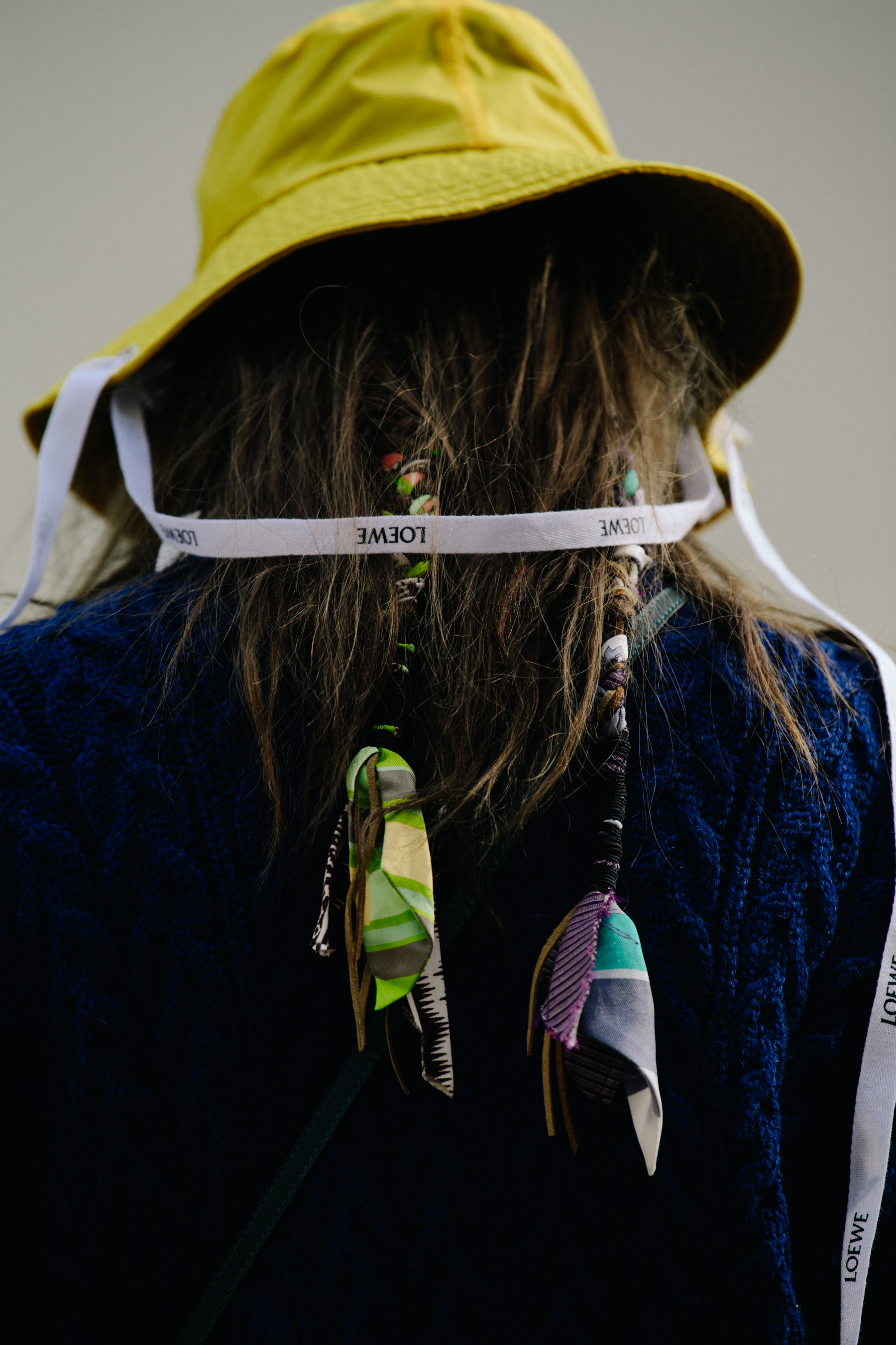 Woman wearing yellow Loewe hat