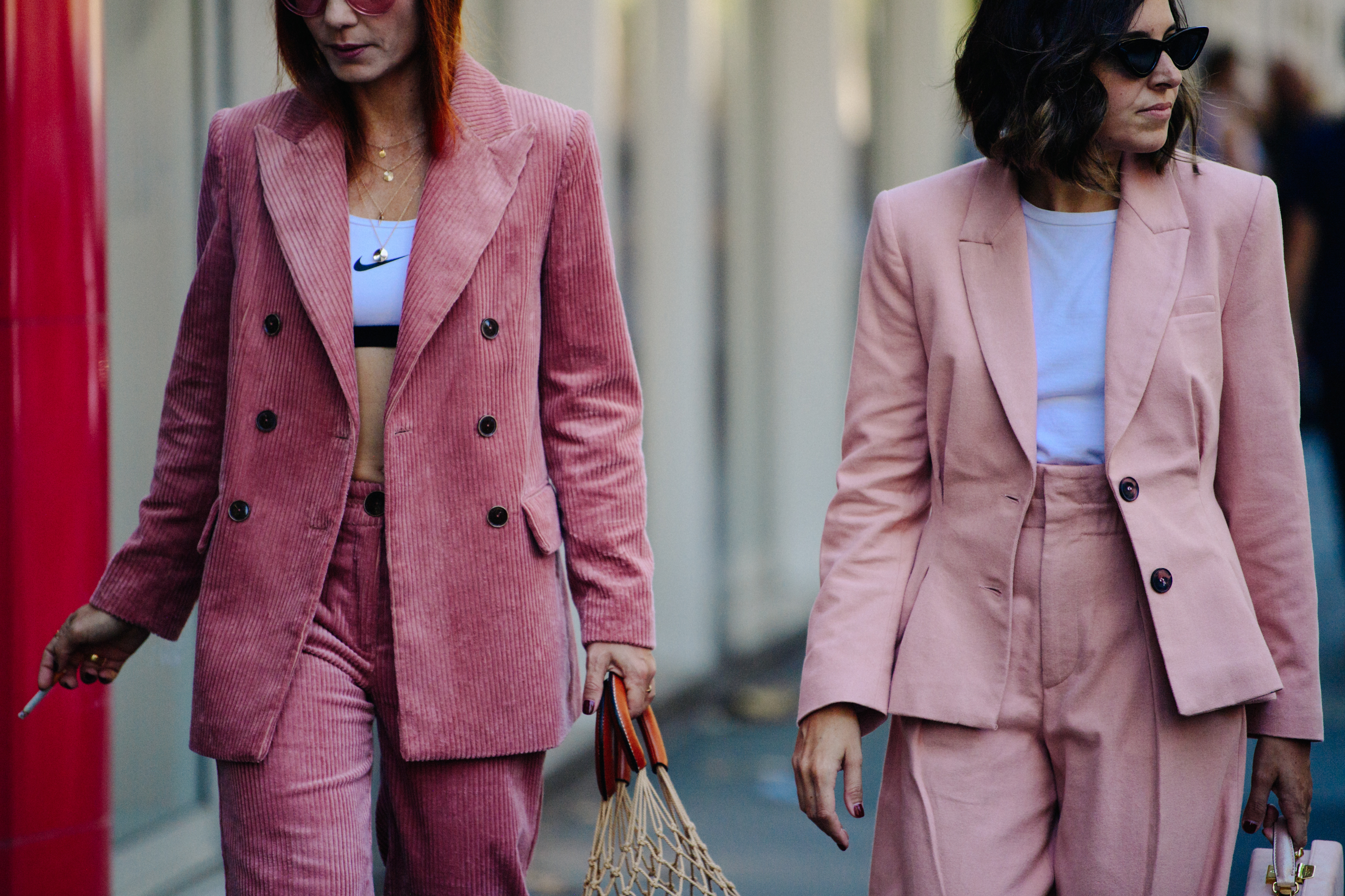 Two women wearing pink suits