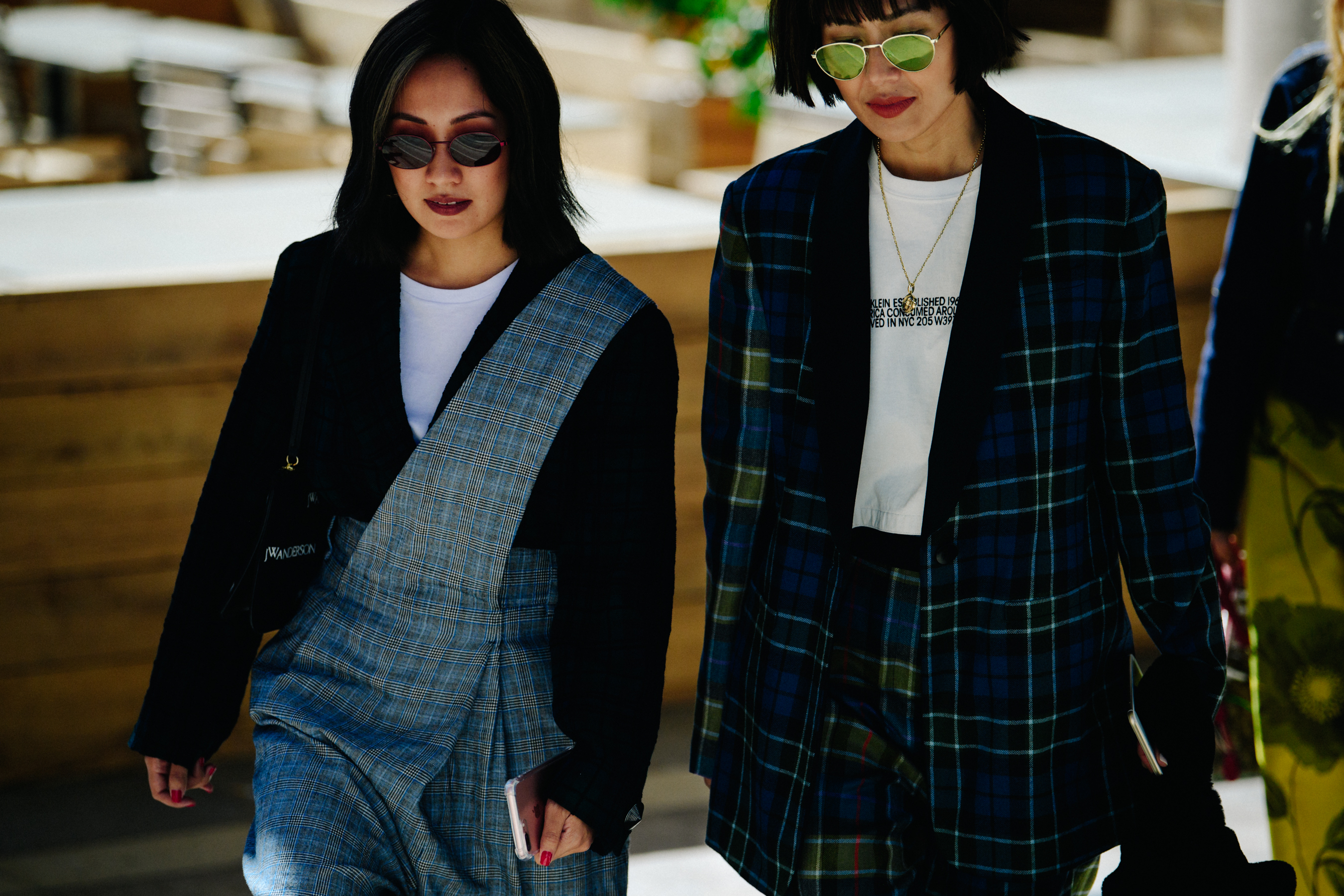 Two women wearing check clothing