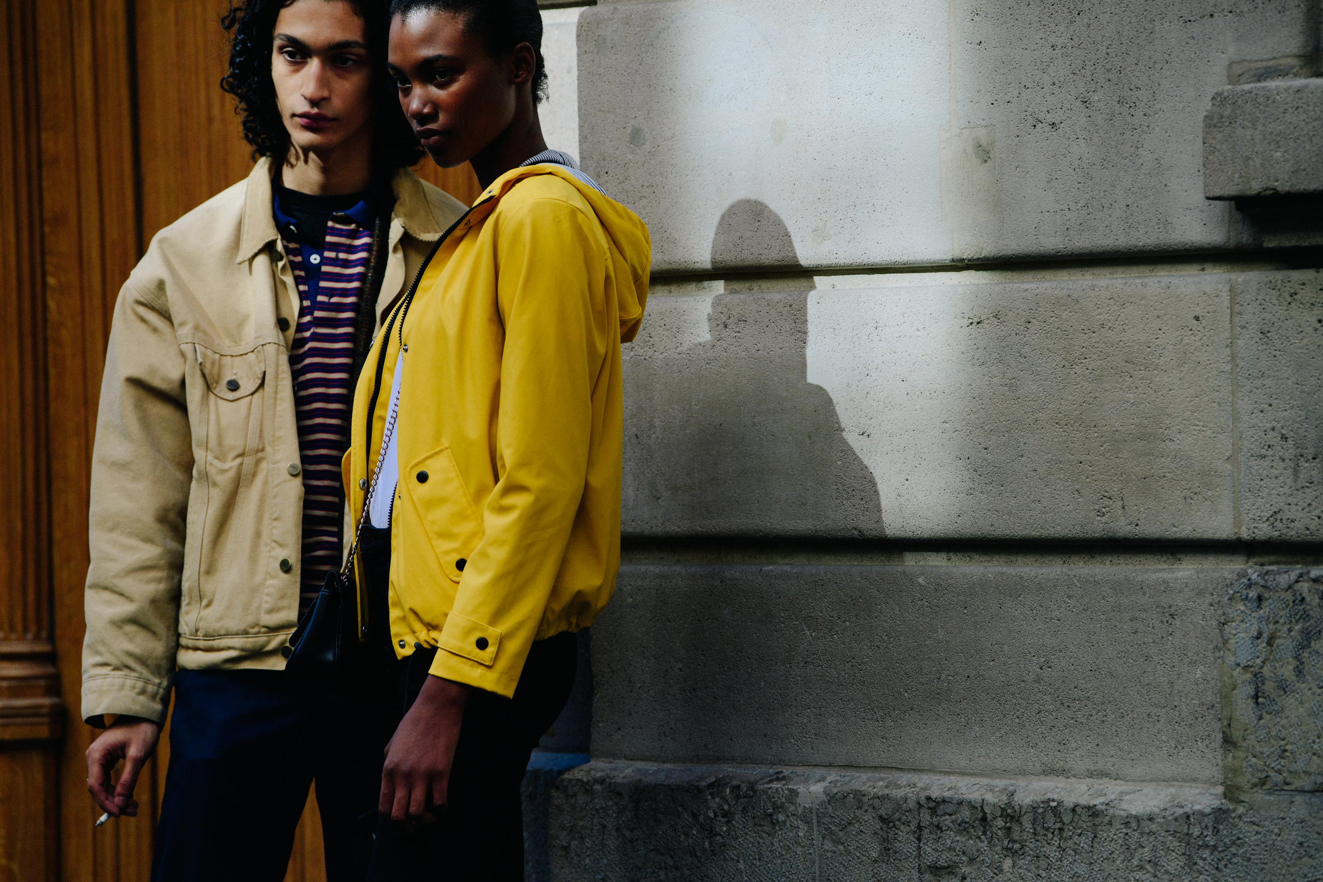Two models wearing yellow and tan