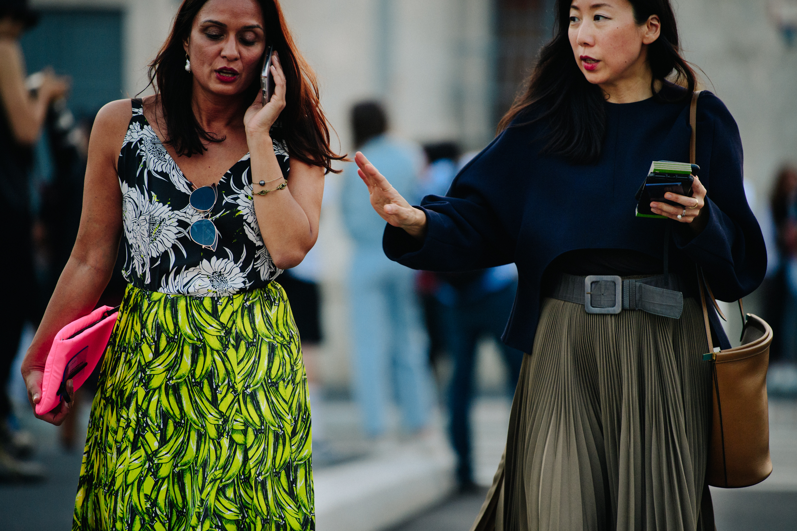 Two women wearing skirts
