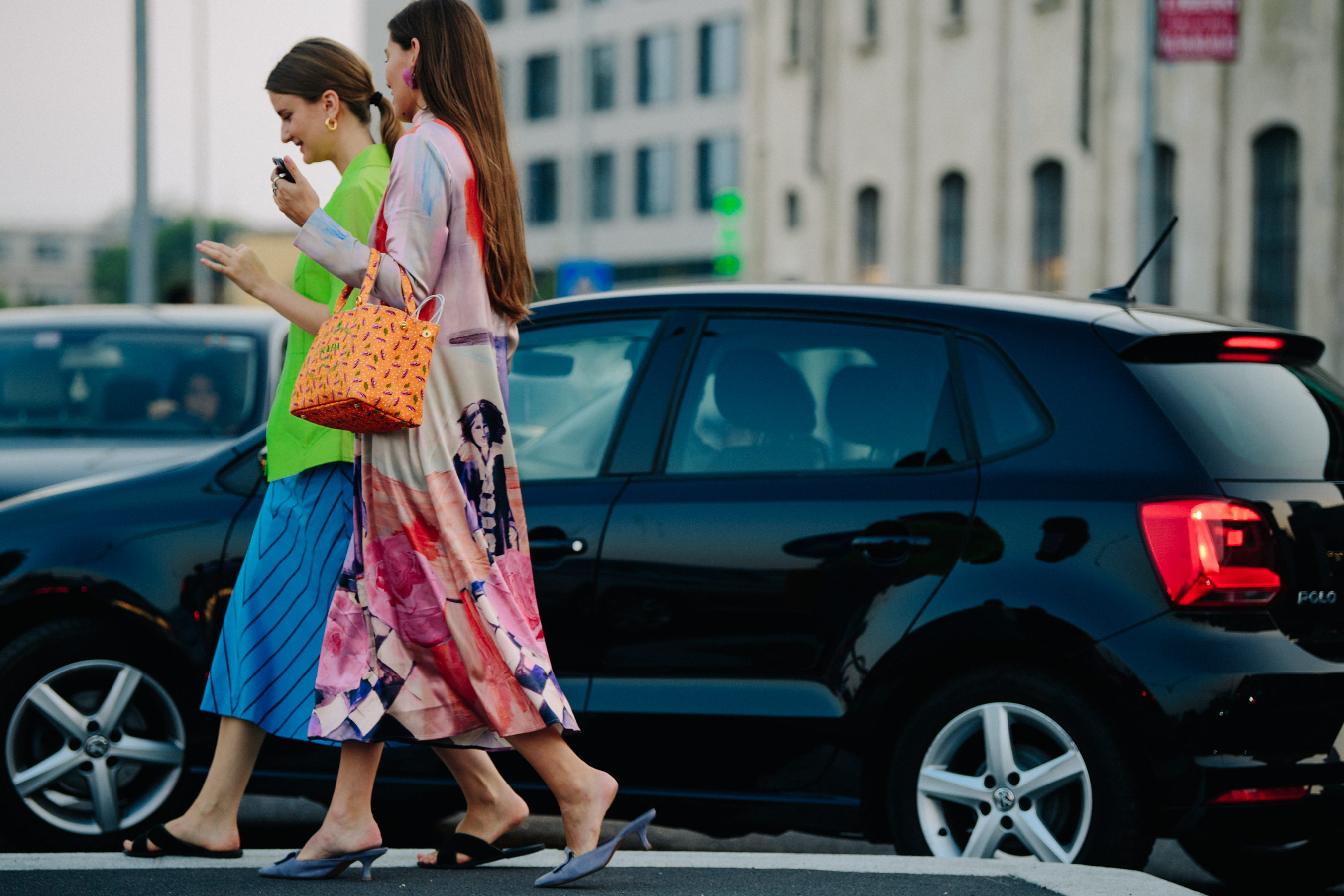 Two women wearing colourful outfits