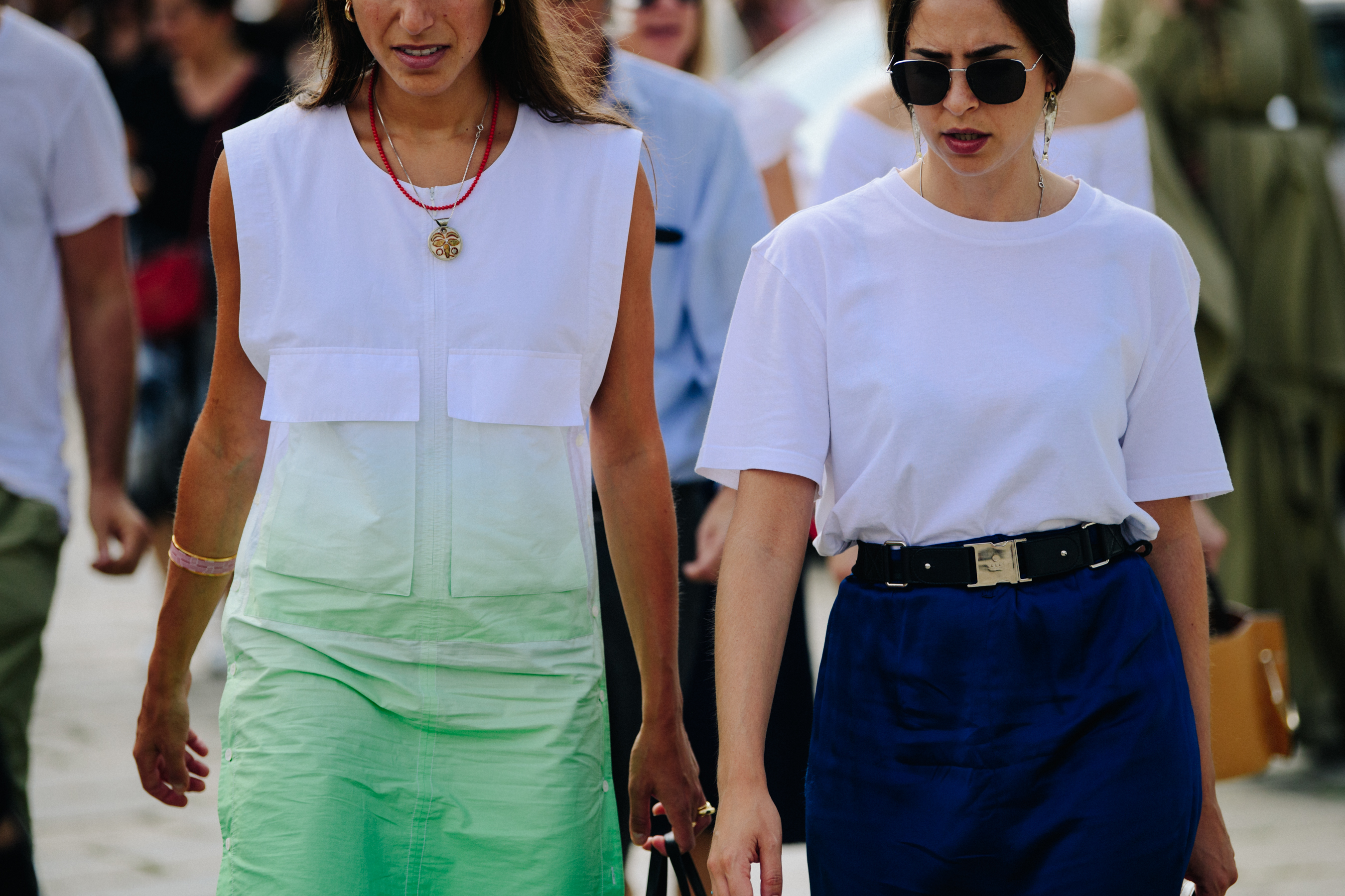 Two women wearing white and colour