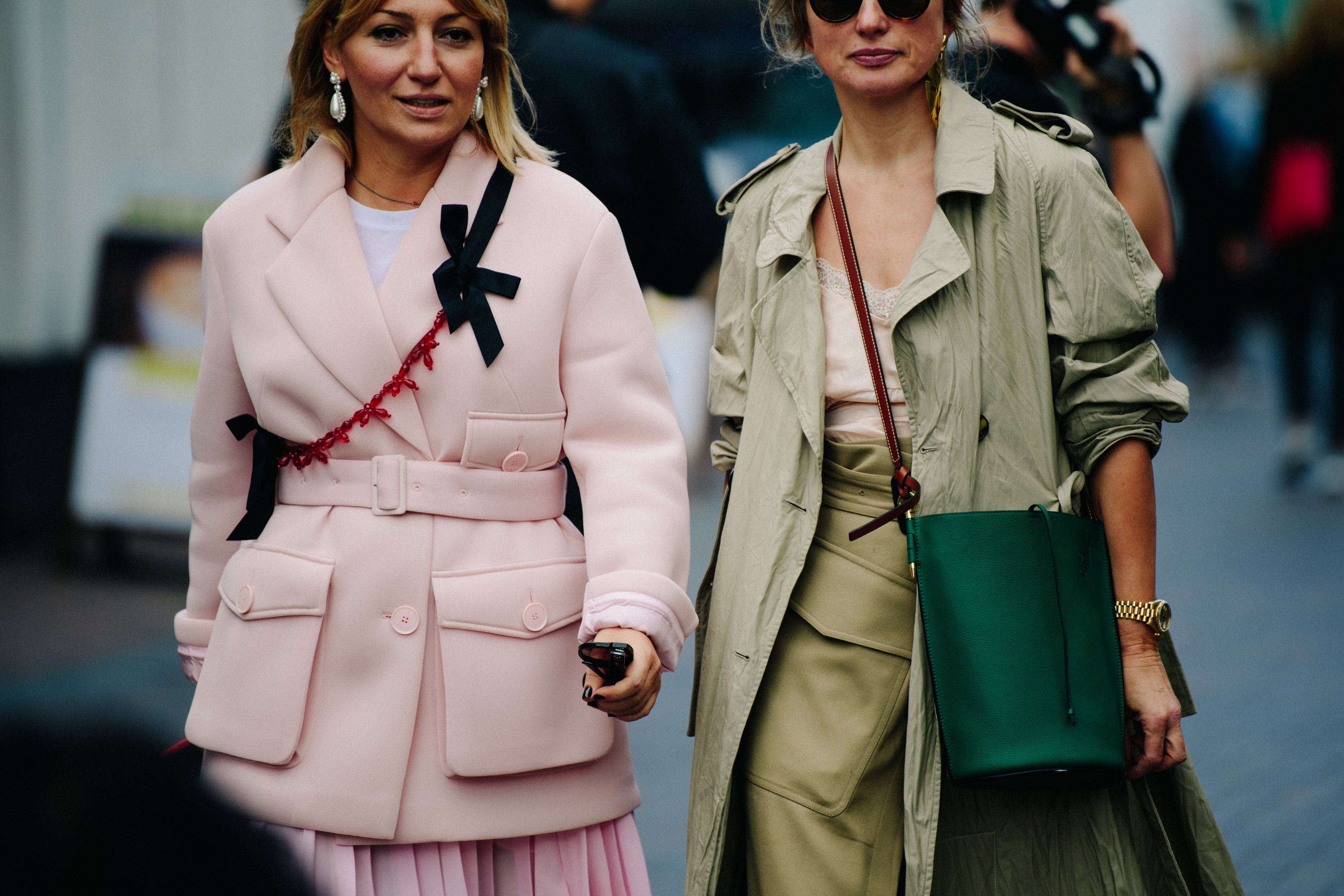 Two women wearing green and pink