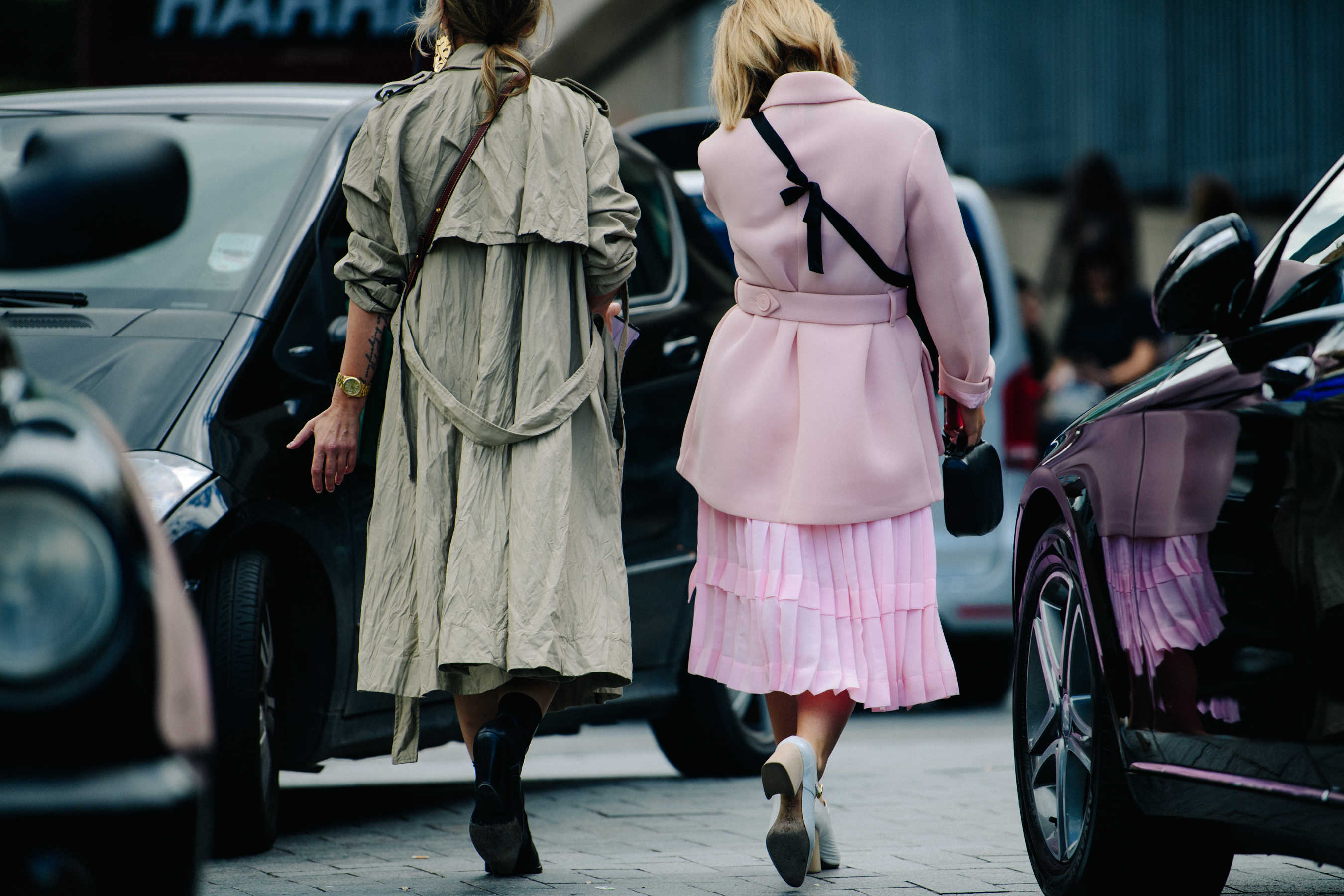 Two women wearing green and pink