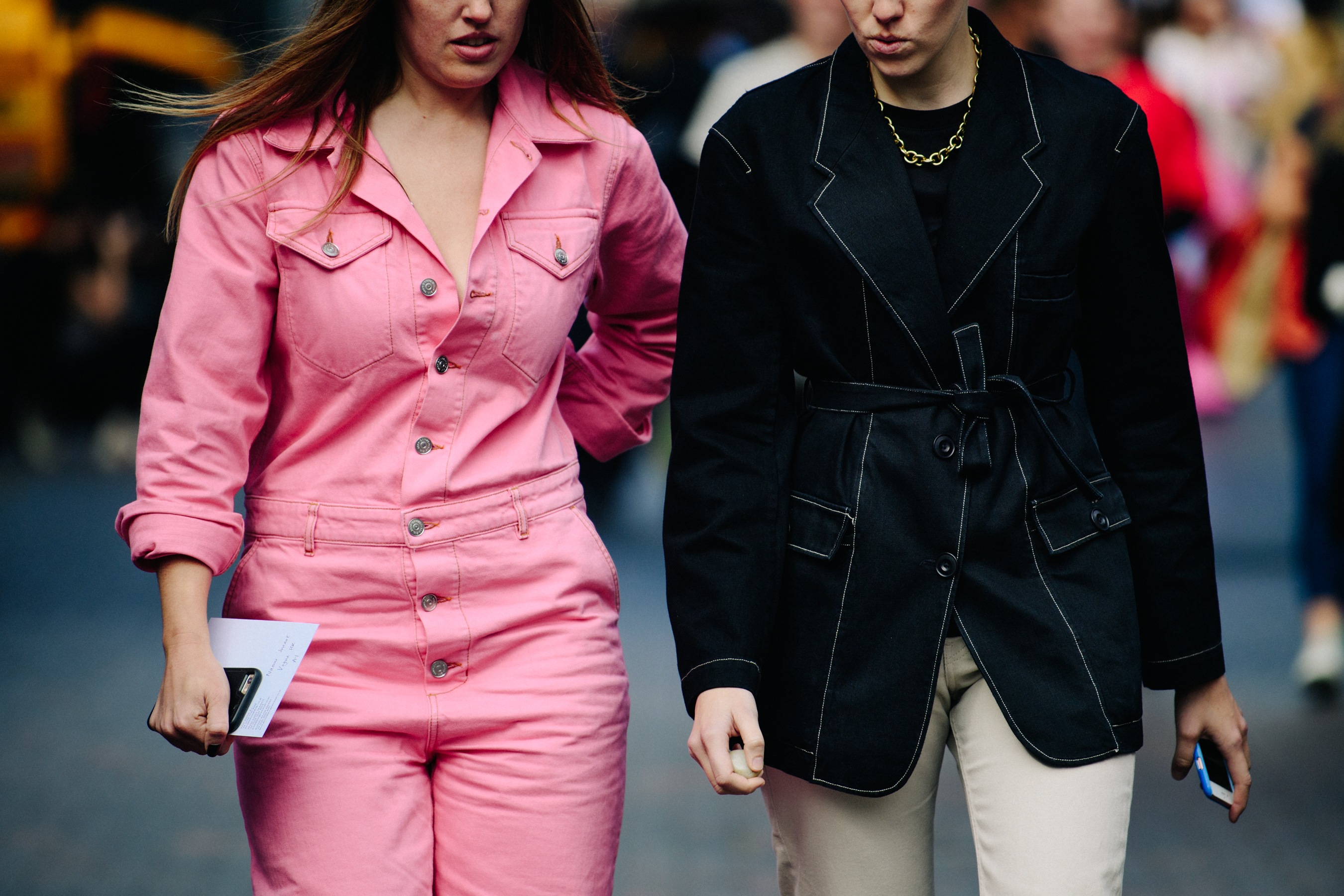 Two women wearing black and pink