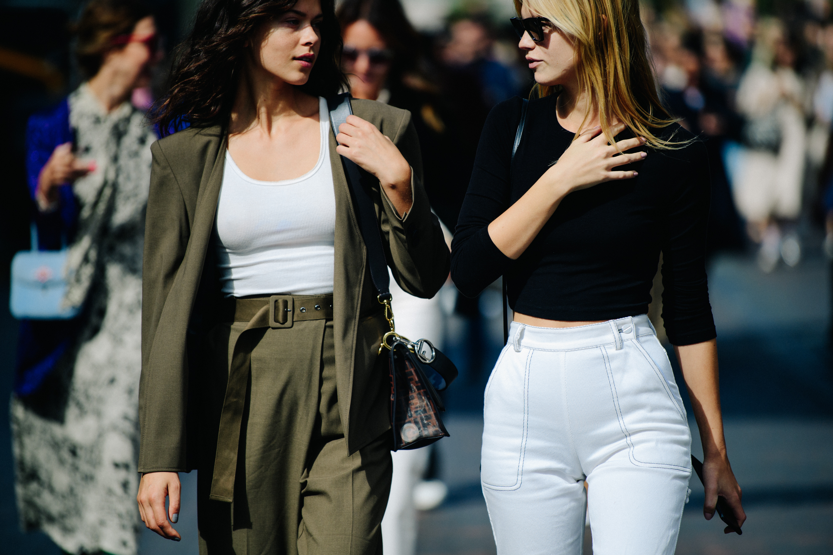 Two models wearing light outfits