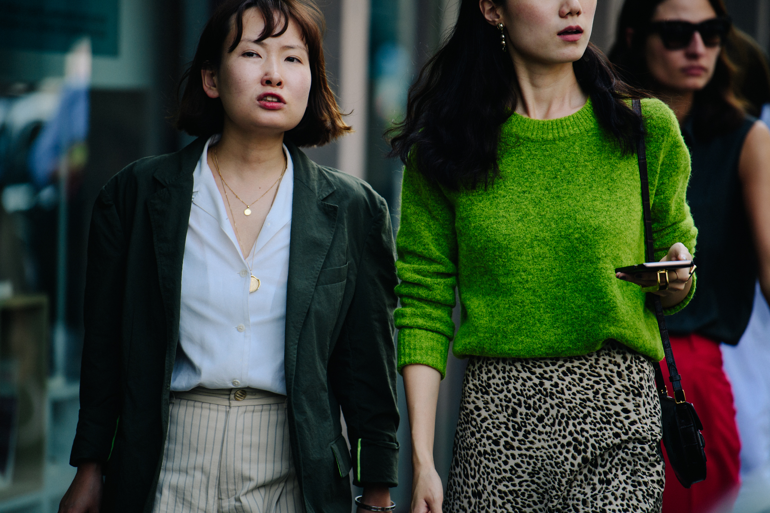 Two Asian women wearing green