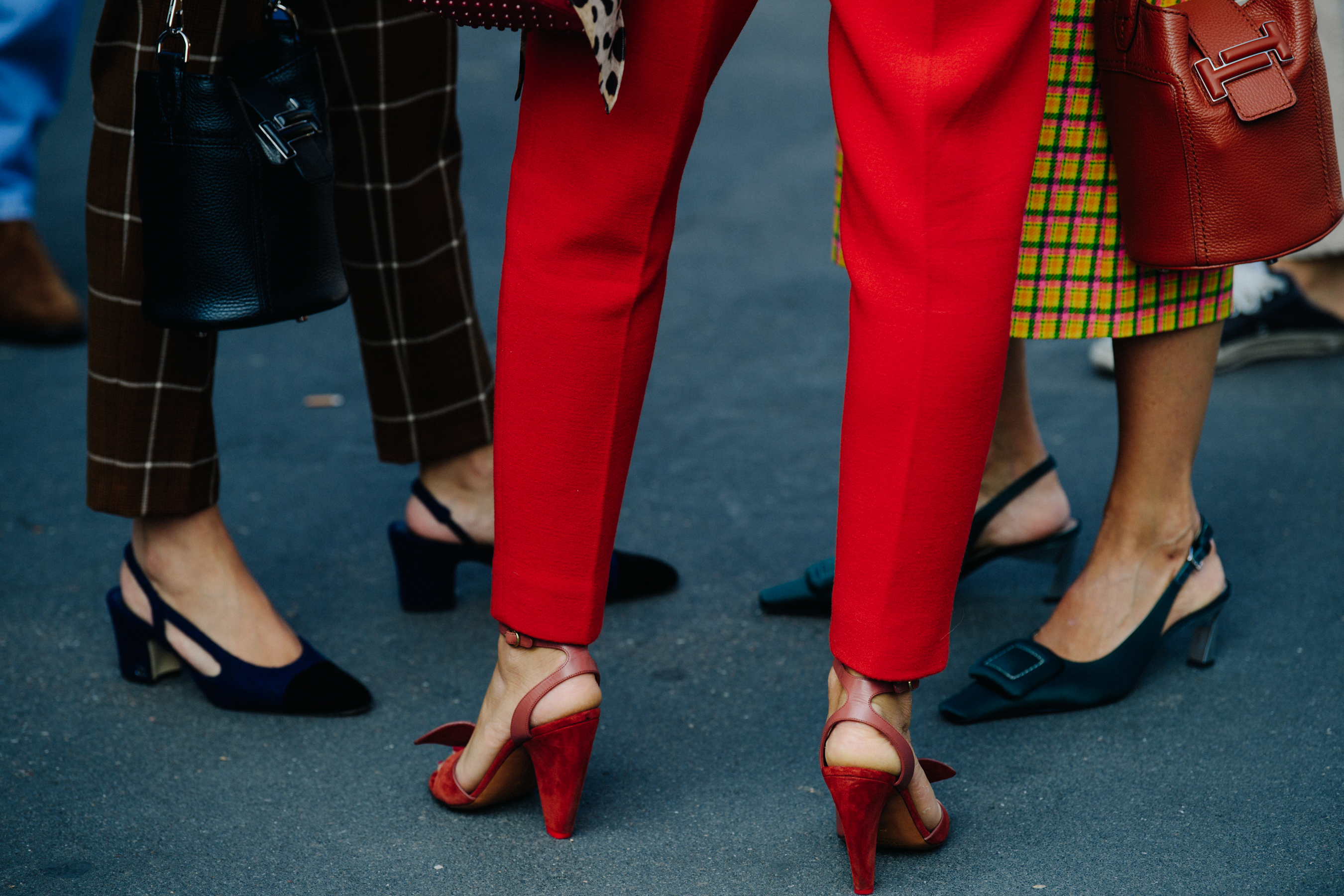 Woman wearing red pants and heels