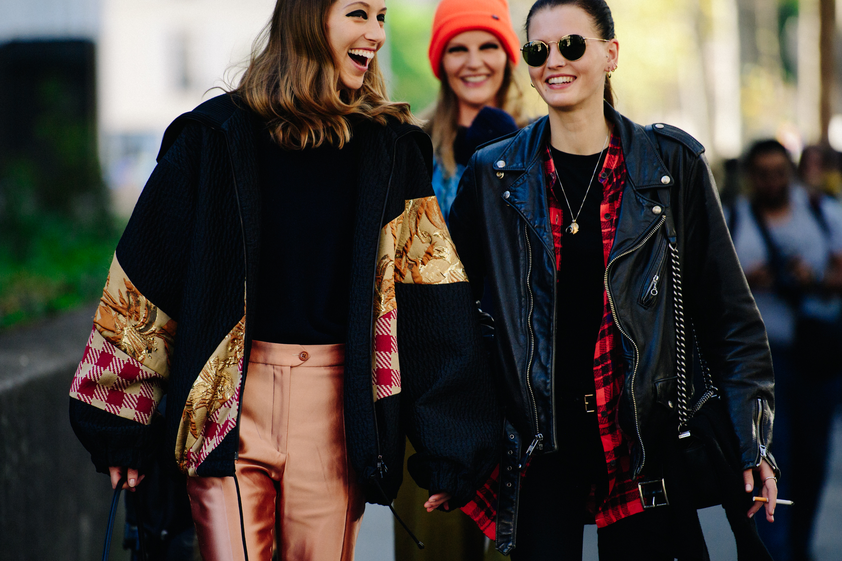 Two models wearing dark coats