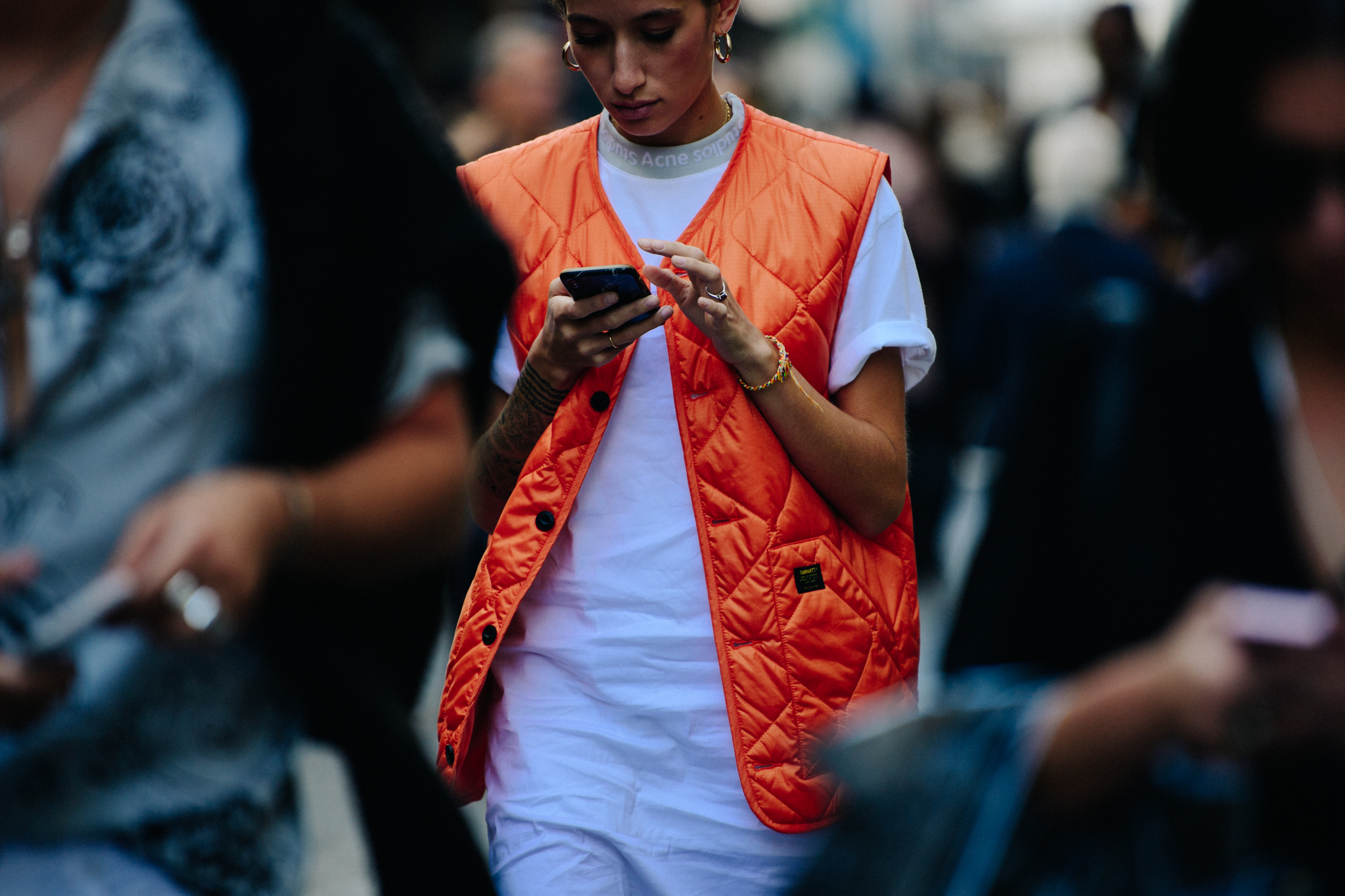 Woman wearing orange Carhartt vest