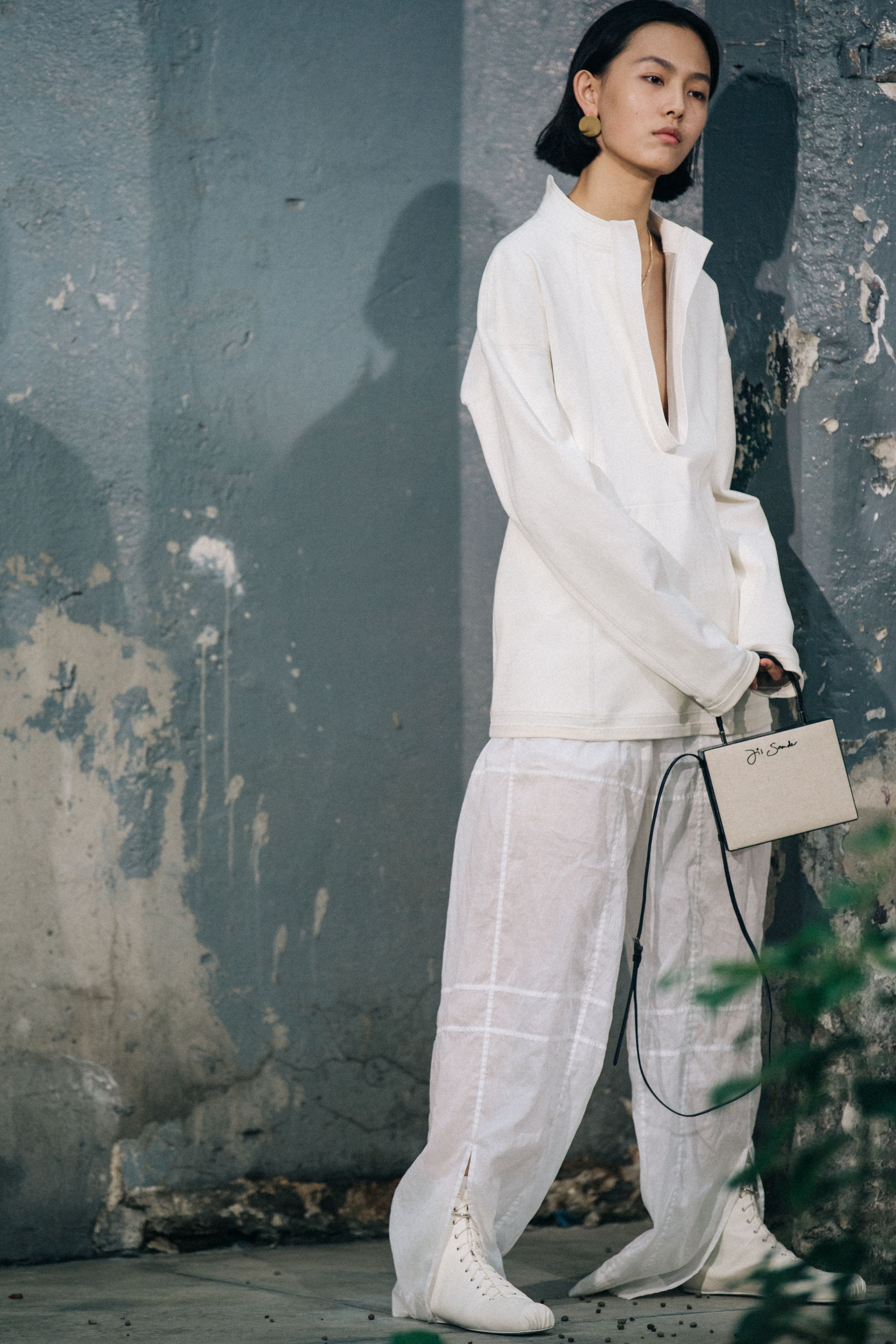 Model wearing white Jil Sander outfit