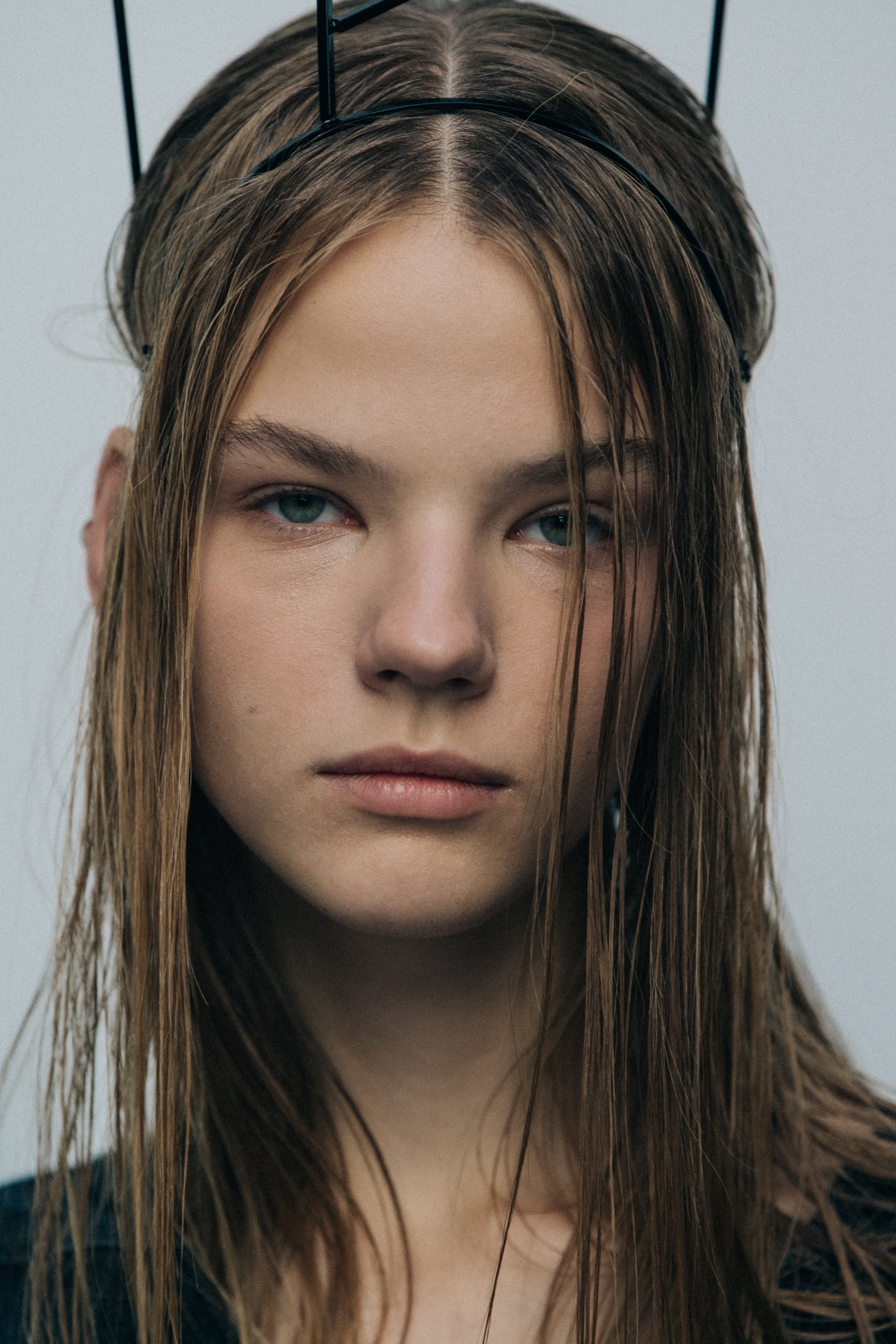 Portrait of model wearing metal structure on head