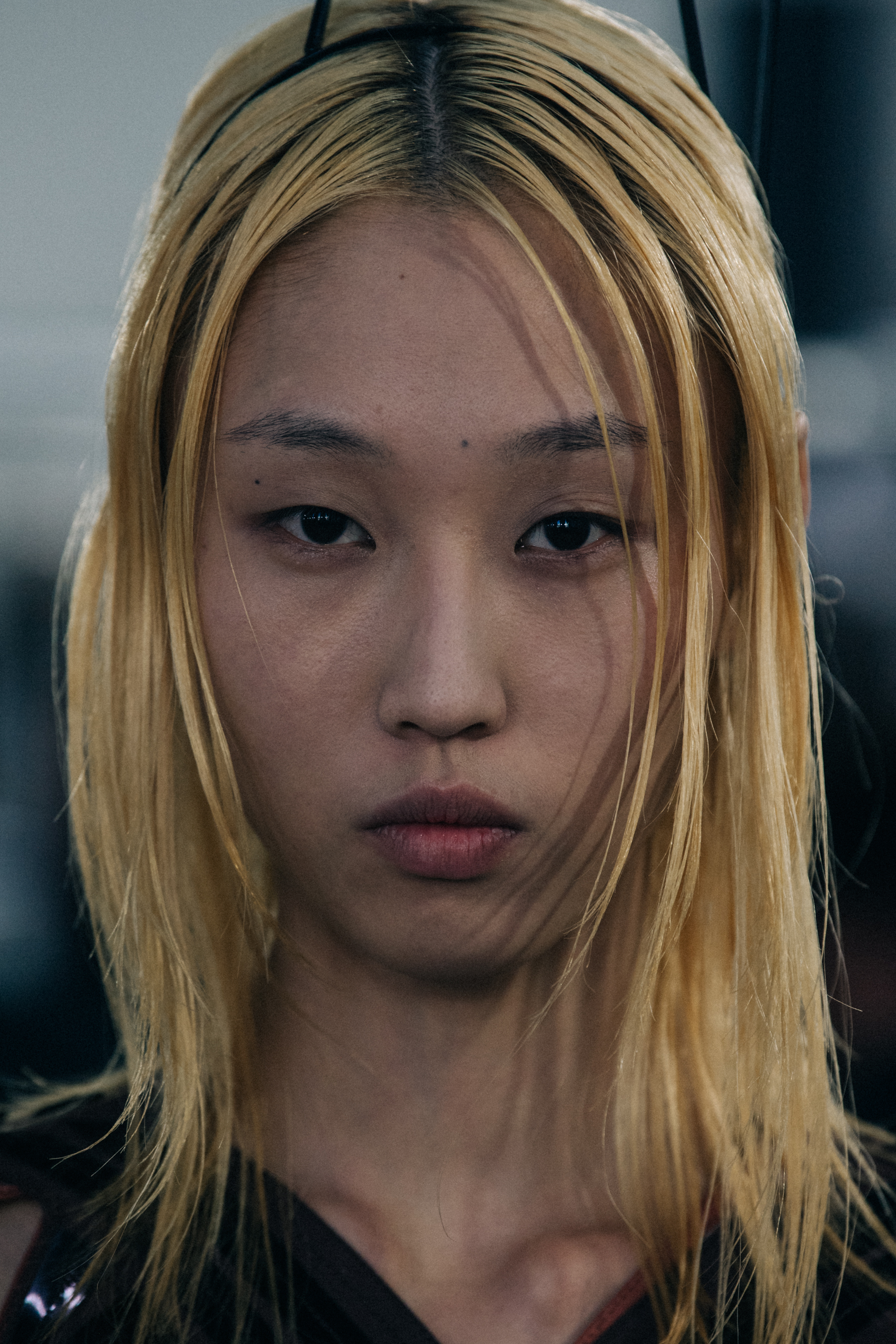 Portrait of model wearing metal structure on head