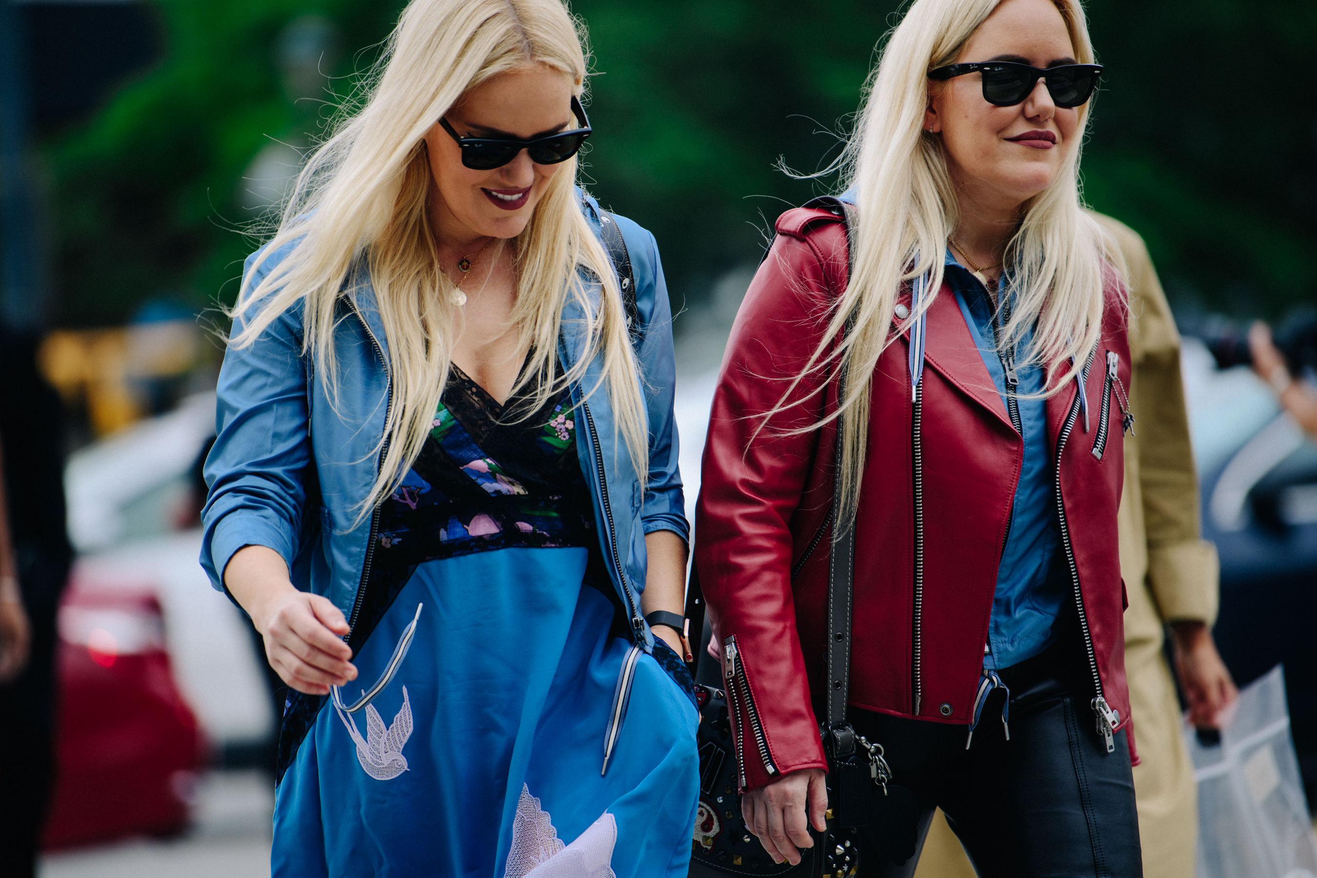 Two blonde women wearing blue and red