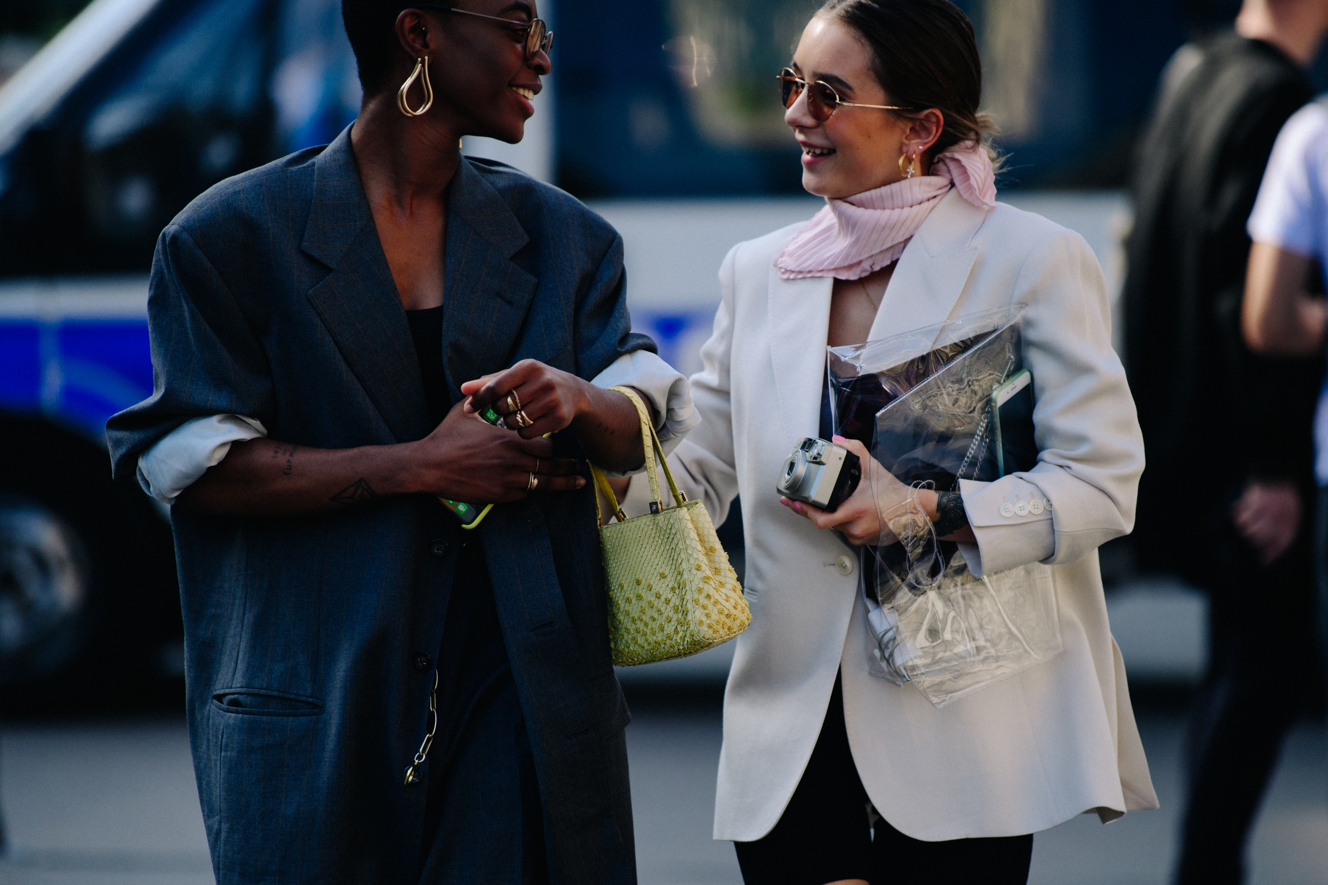 Two women wearing white and black suits