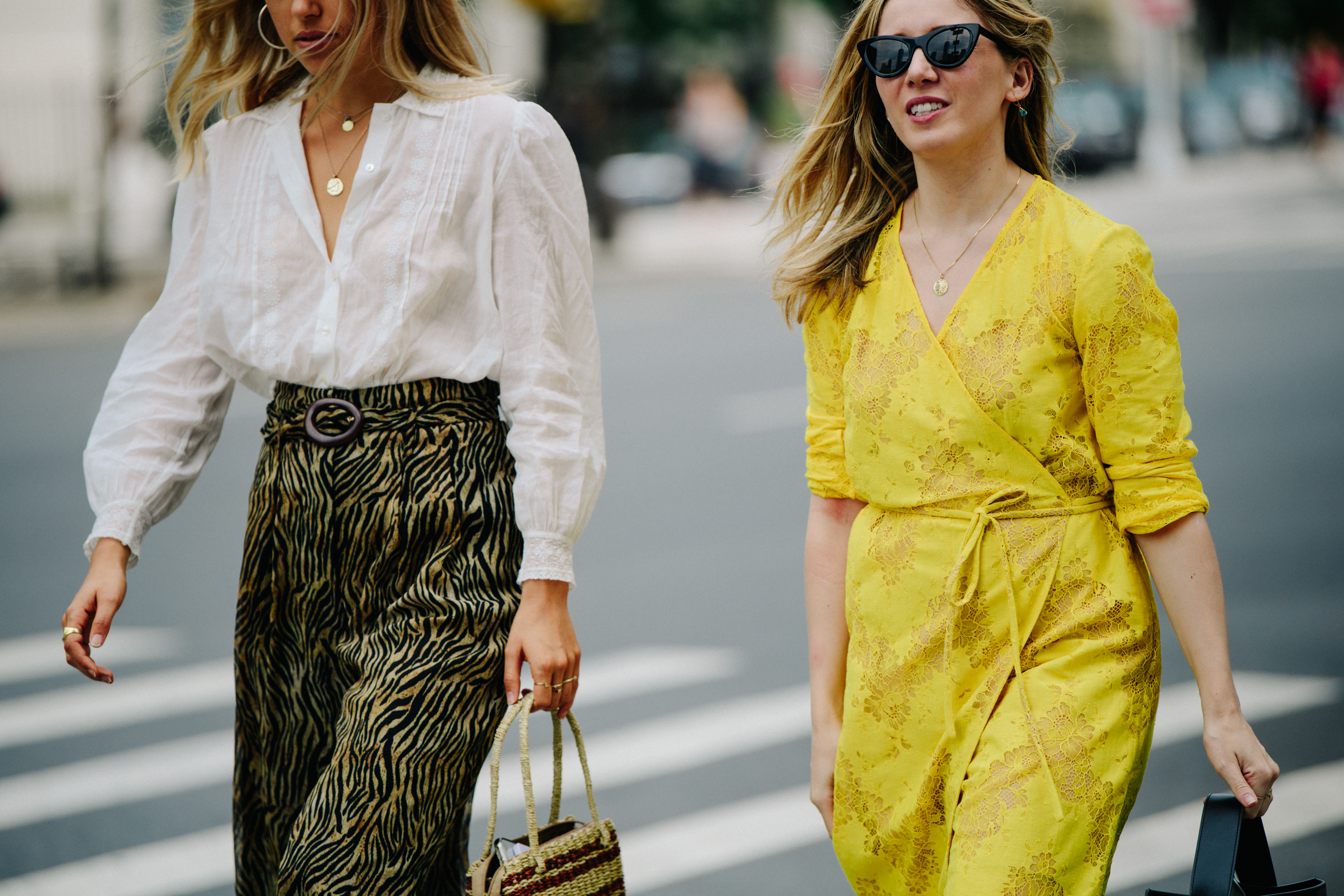 Two women wearing light outfits