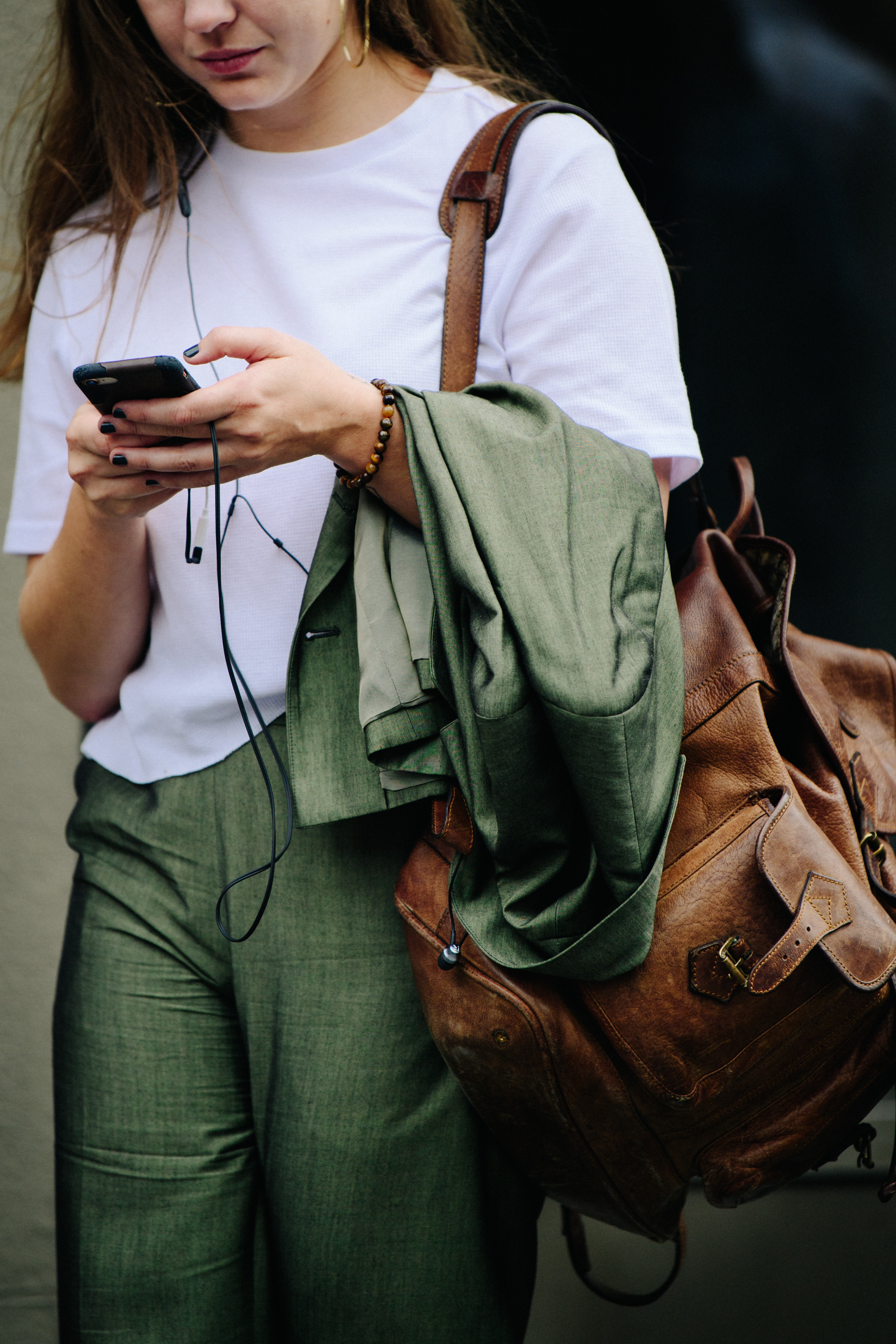 Woman carrying green jacket