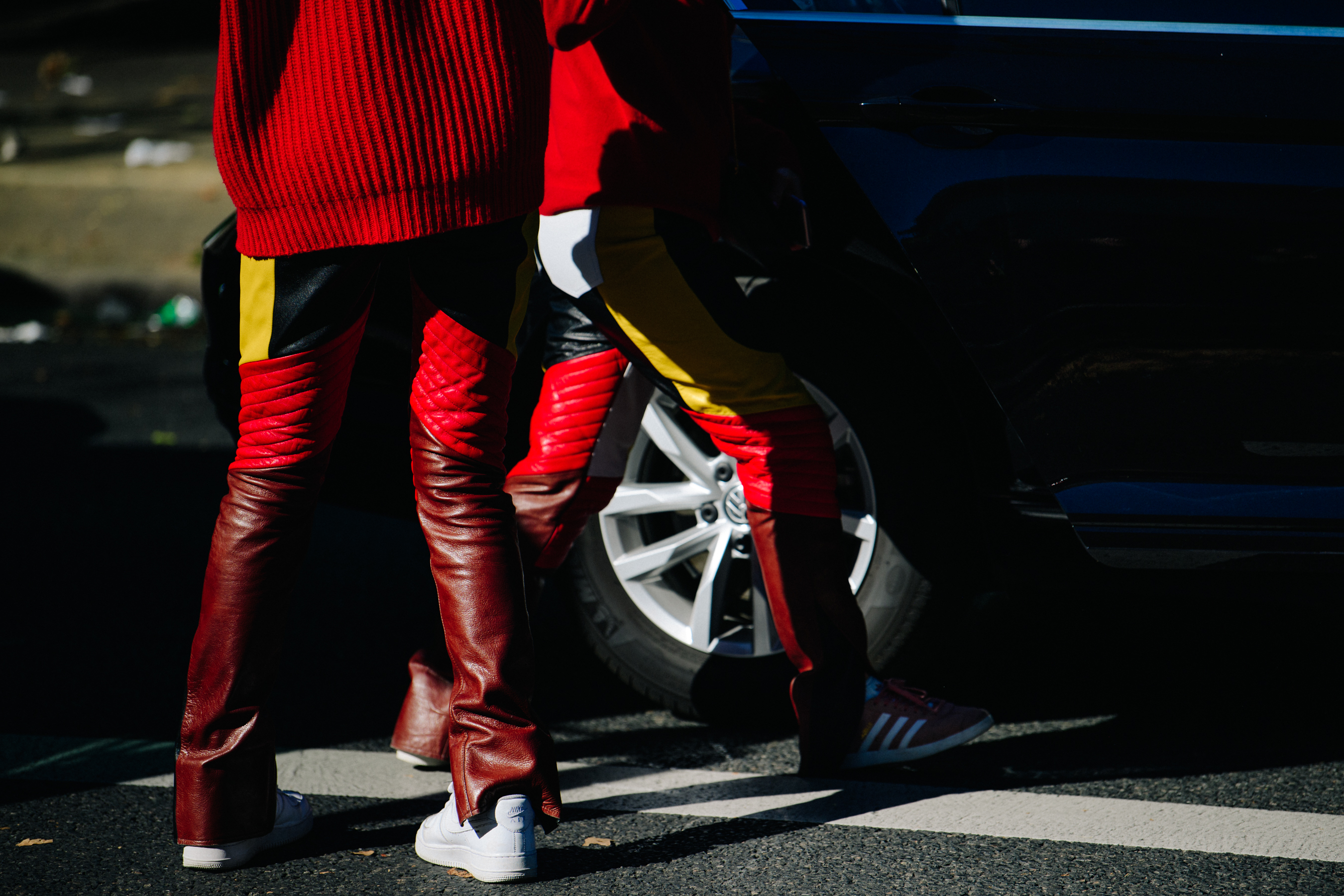 Two people wearing red leather pants