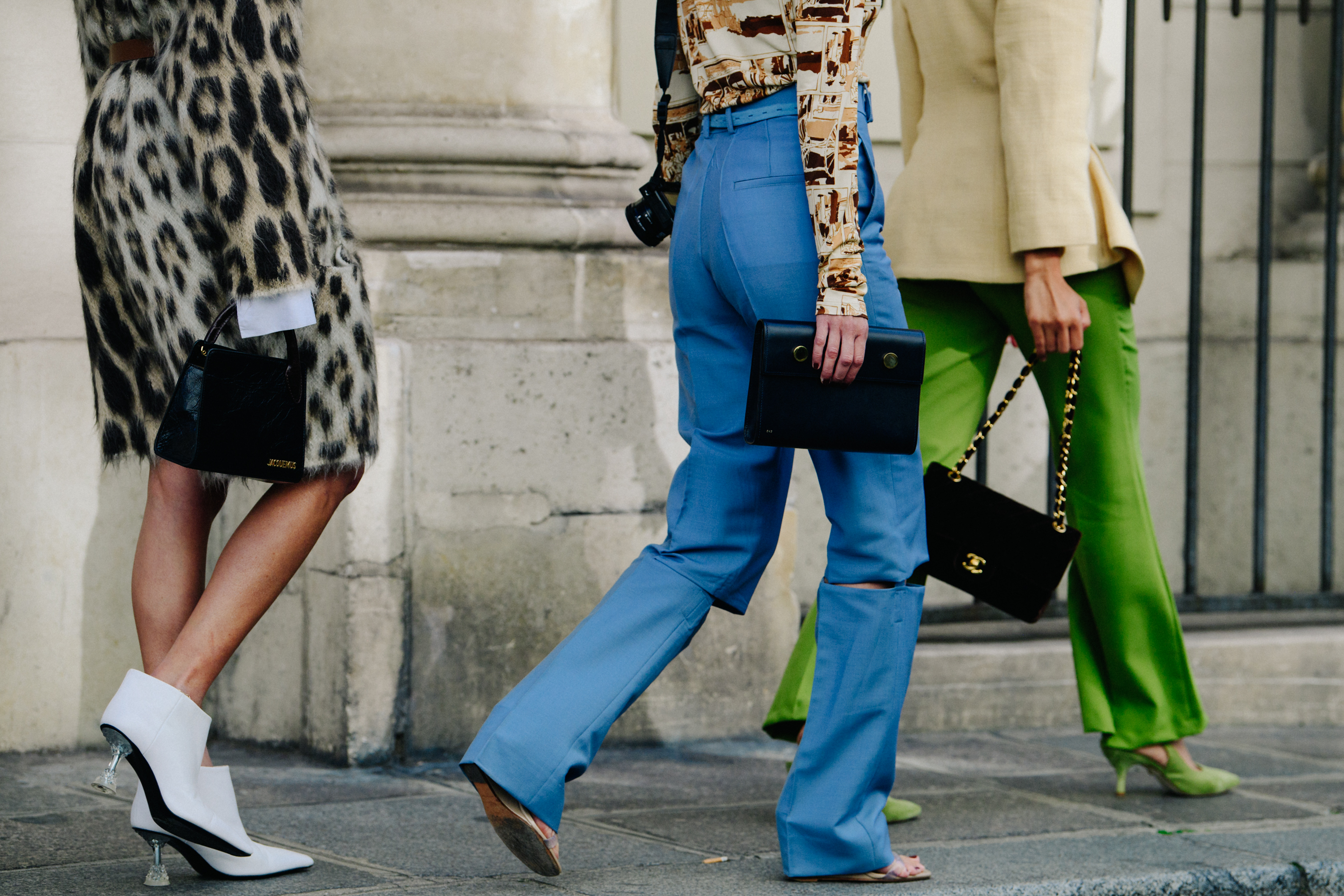 Three women carrying designer bags