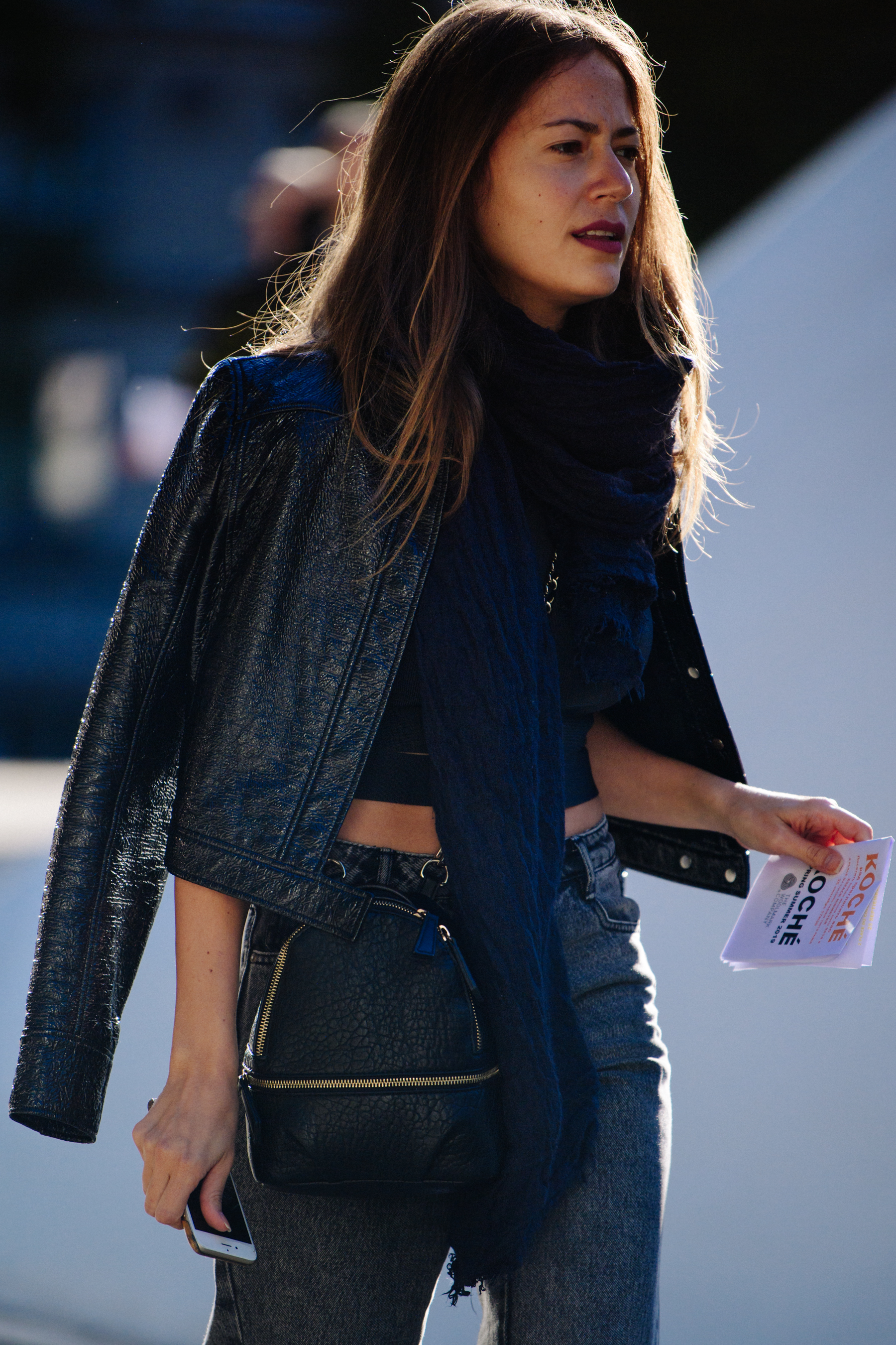 Woman wearing black patent jacket