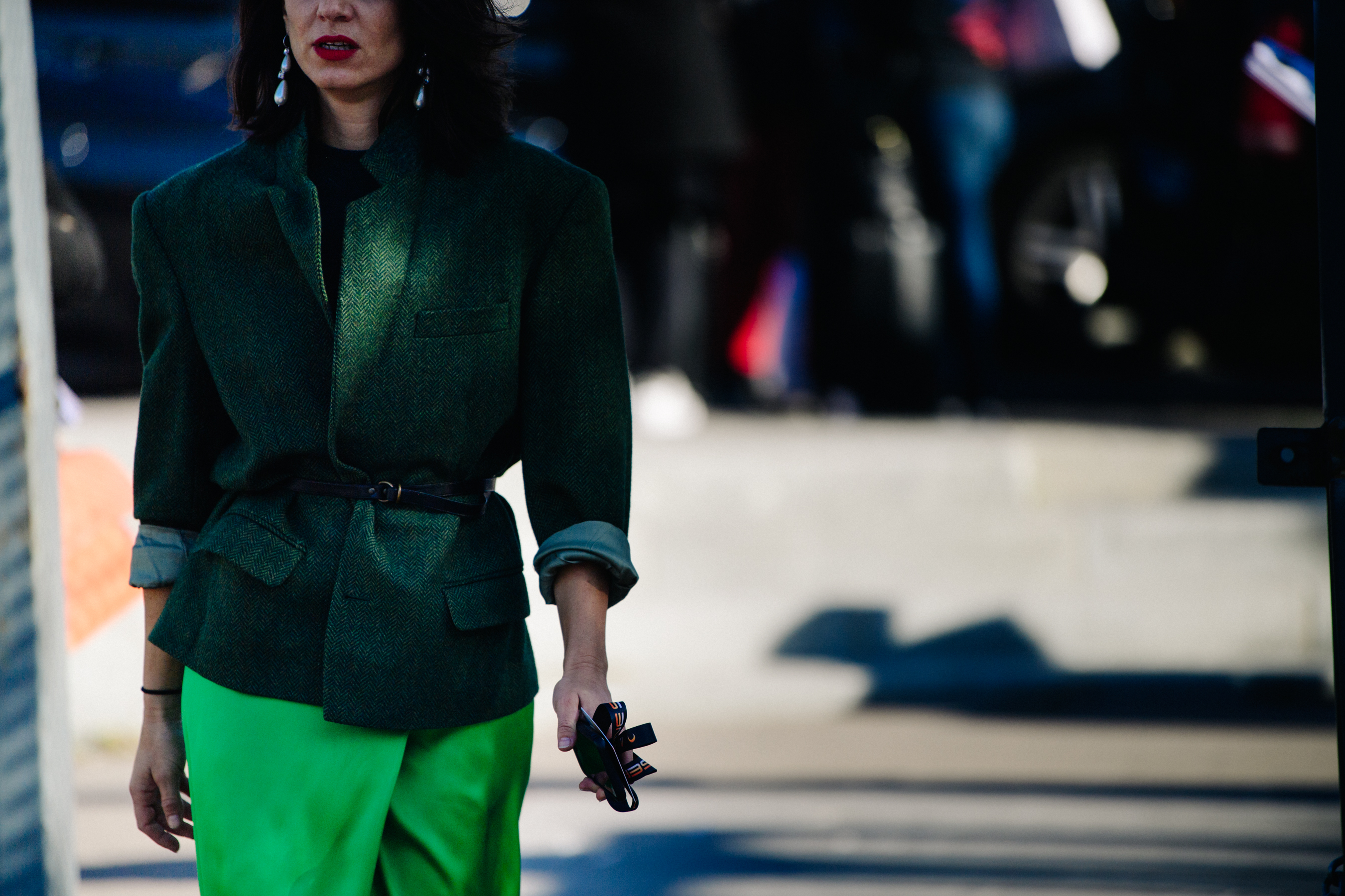 Woman wearing green jacket and skirt