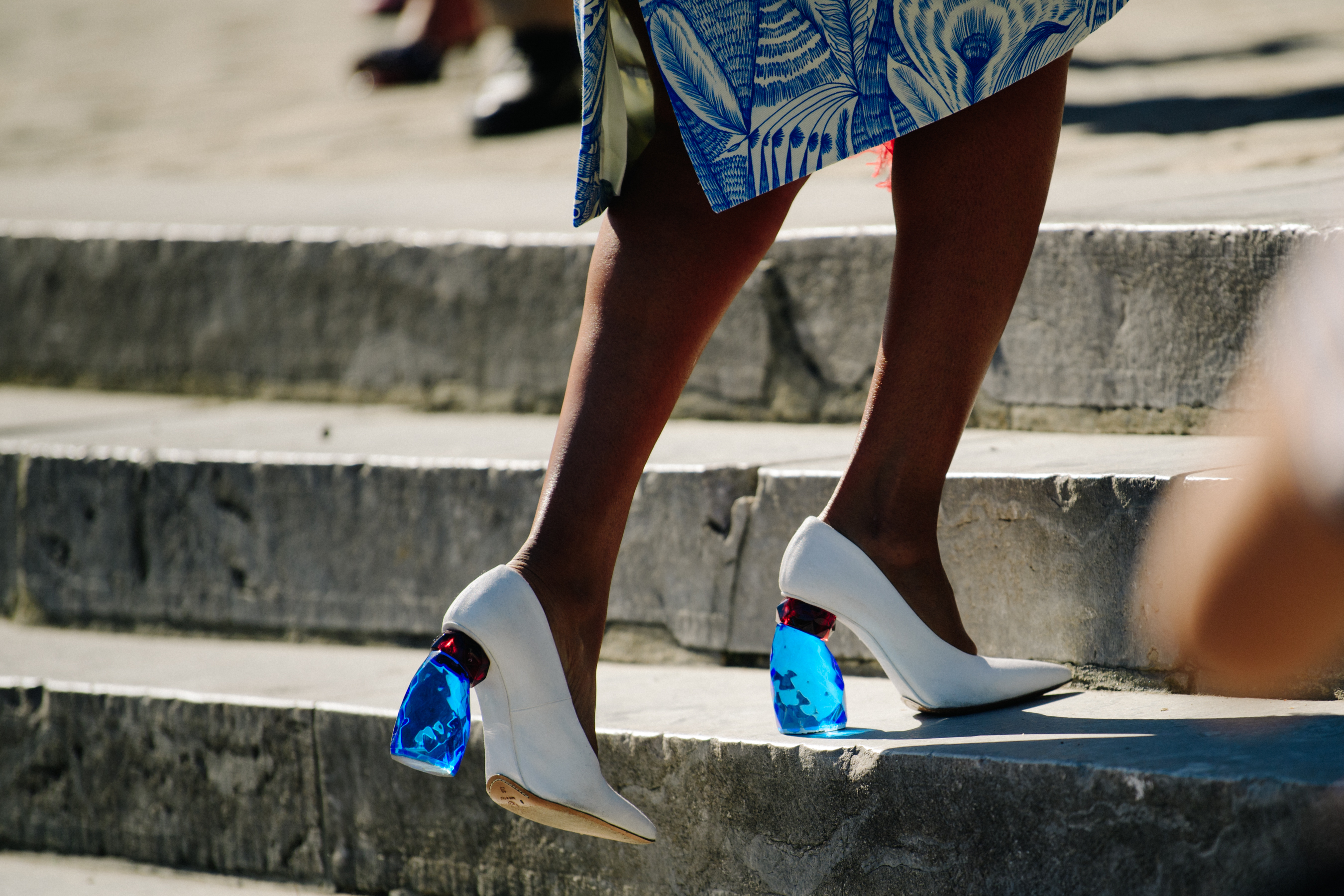 Woman wearing blue plastic heels